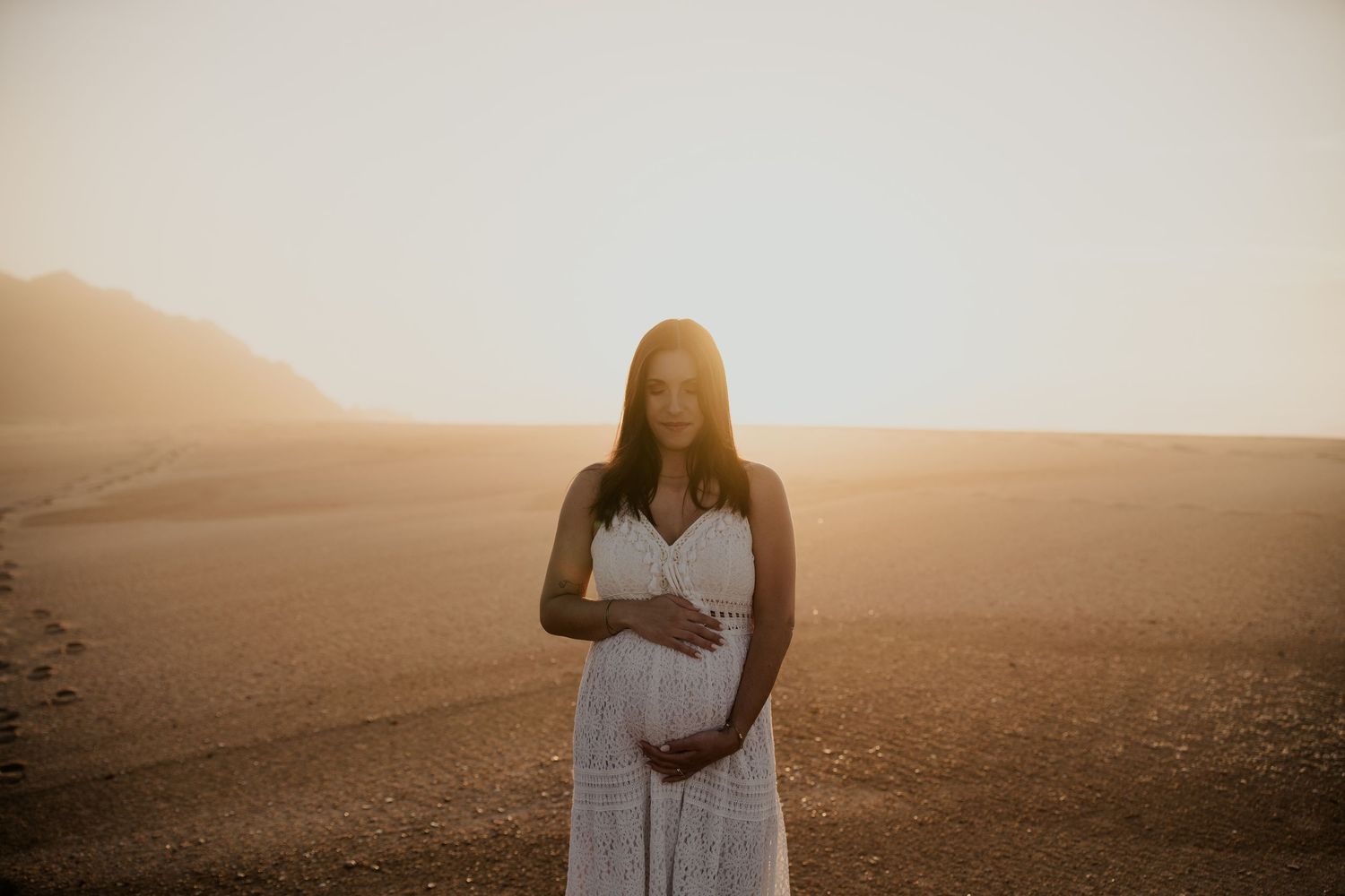 A series of sepia-toned beach wedding photographs showing a romantic seaside ceremony at sunset.