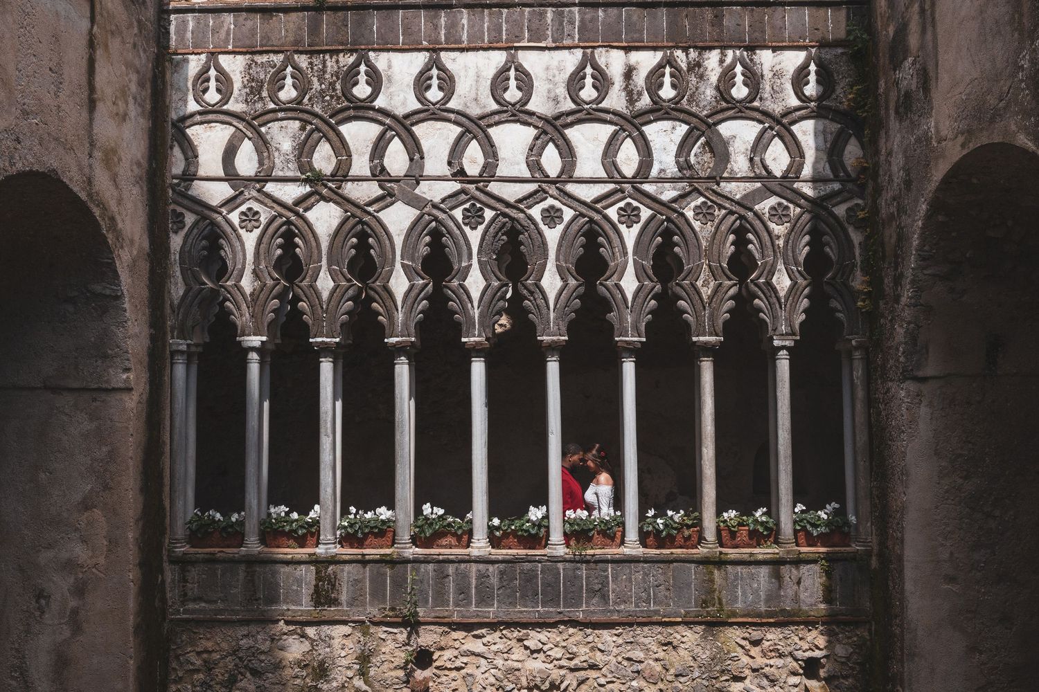 Gothic stone archway with ornate tracery and columns at Siena Cathedral in Italy displays medieval architectural detail.