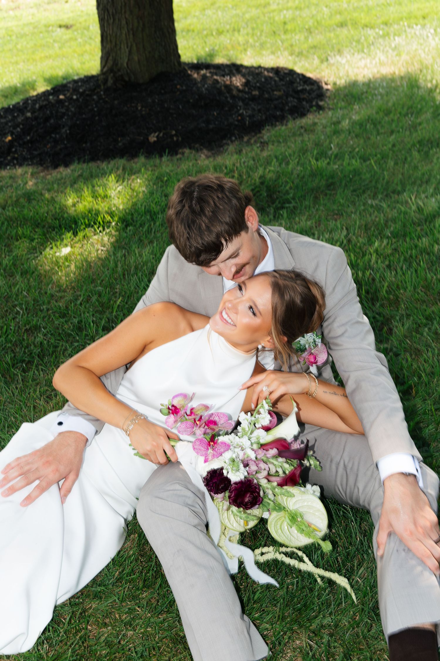 Newlyweds laughing together during their wedding portraits