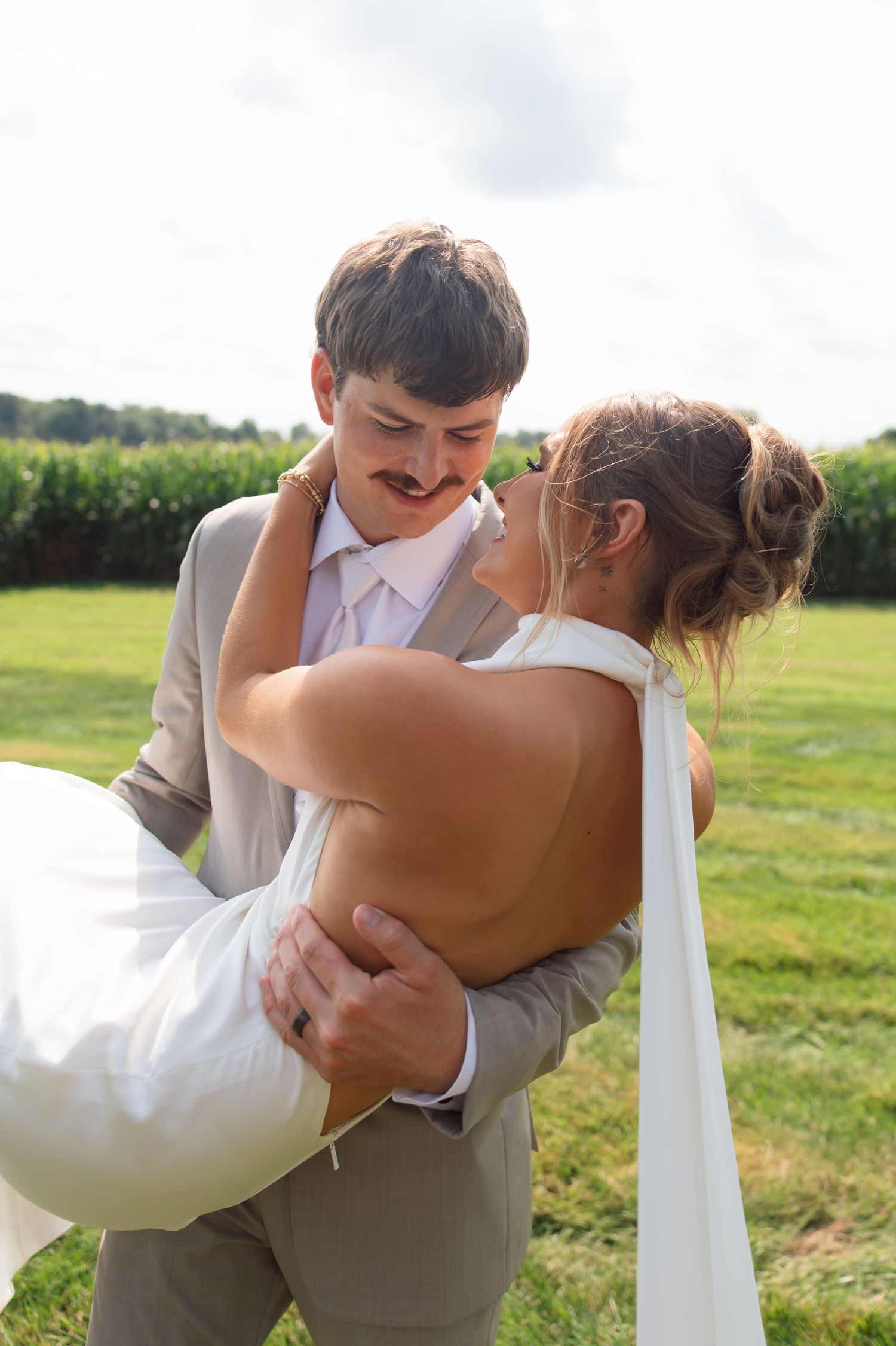 Bride and groom embracing during an outdoor wedding portrait