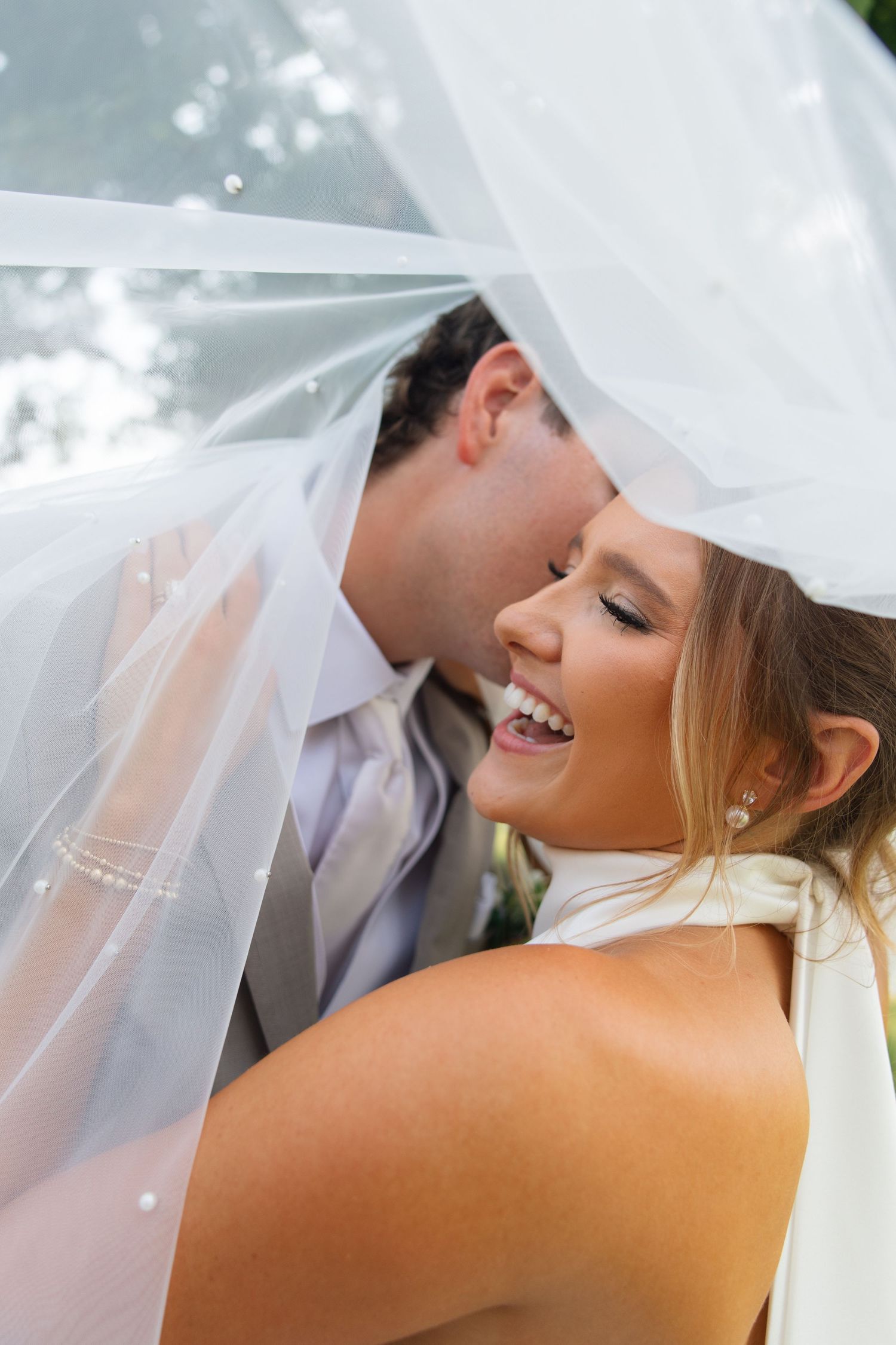 Bride and groom sharing a romantic moment during their wedding portraits