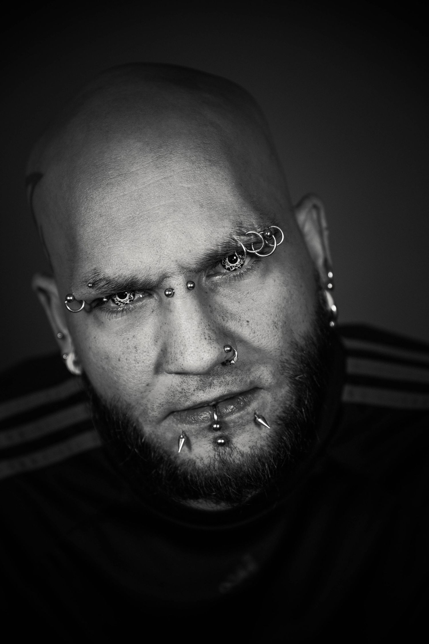 Moody studio portrait with dramatic lighting, deep shadows, and rich contrast, creating an intimate, artistic, and striking image.