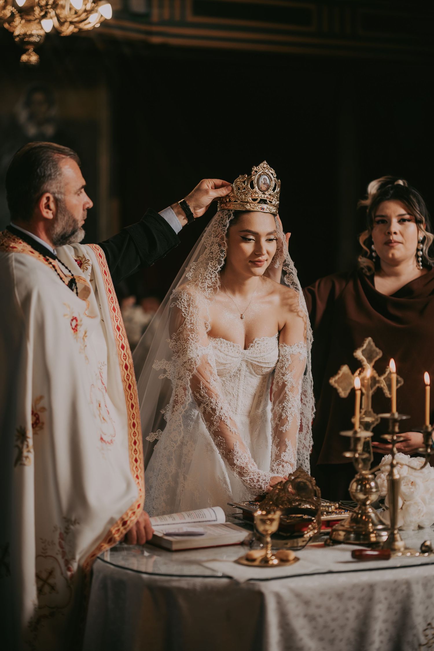 Priest placing crown on bride during Orthodox Christian wedding ceremony.