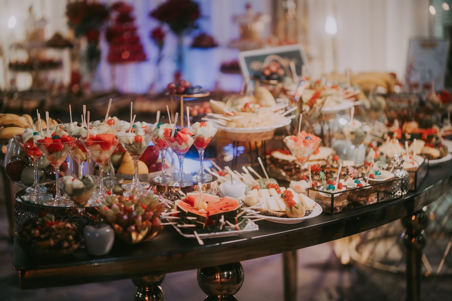 Elegant wedding appetizer display table with colorful canapes and decorative picks at a reception. Epicu Fotograf Drobeta-Turnu Severin