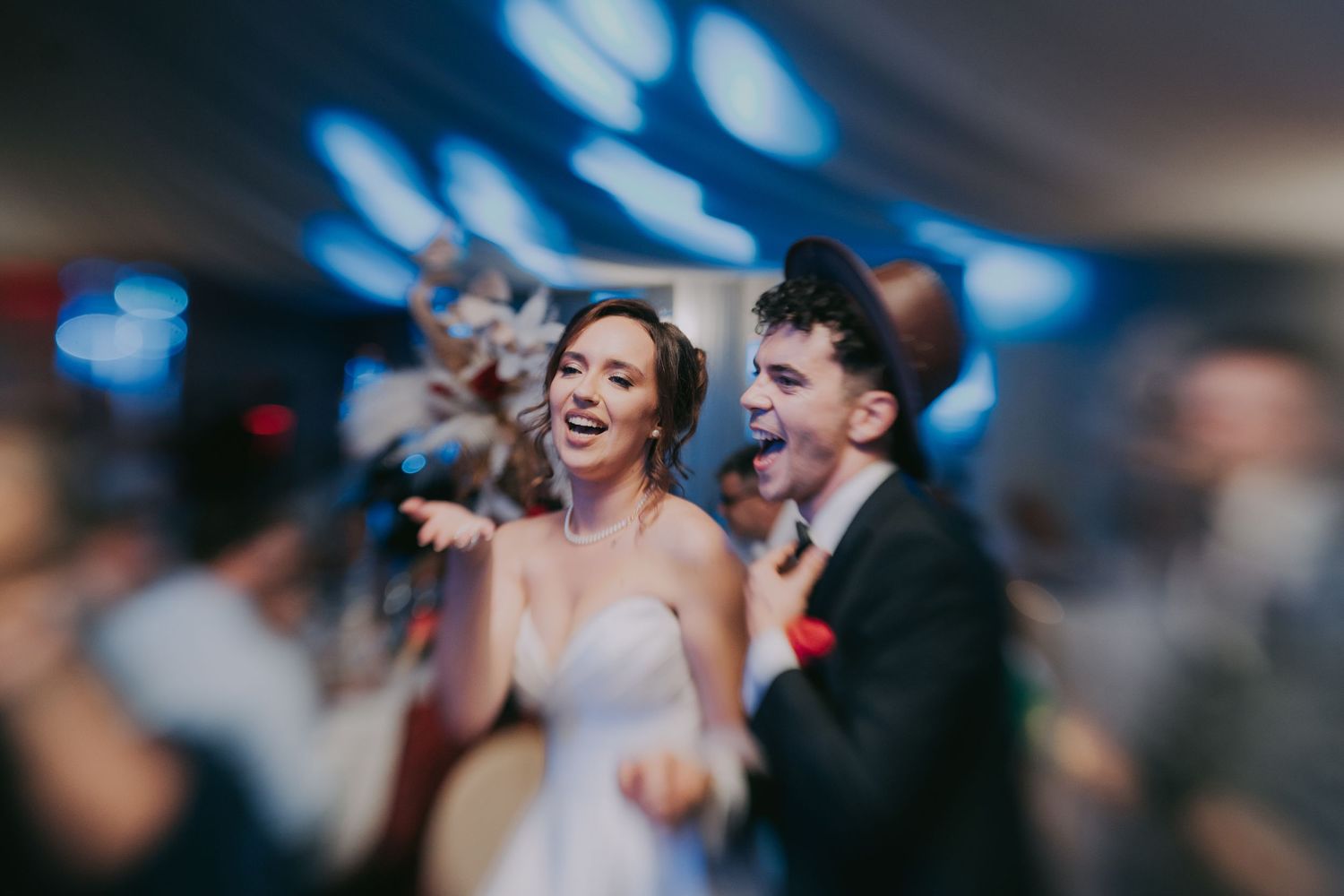Happy bride and groom laughing and celebrating together on the wedding reception dance floor. Epicu Fotograf Drobeta-Turnu Severin