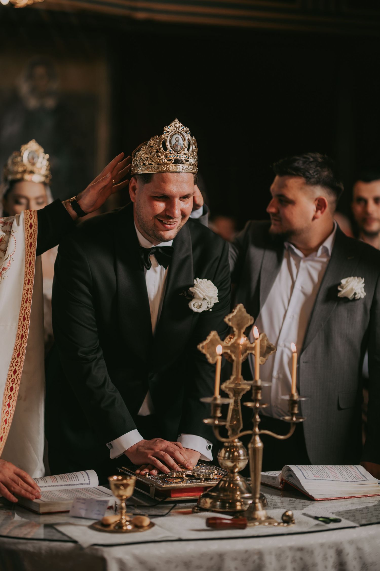 Groom crowned during Orthodox wedding ceremony at church altar.