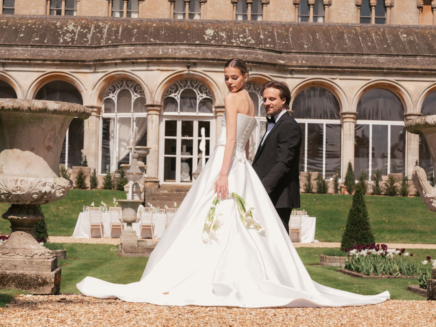 Bride and groom against backdrop at a Cotswolds venue