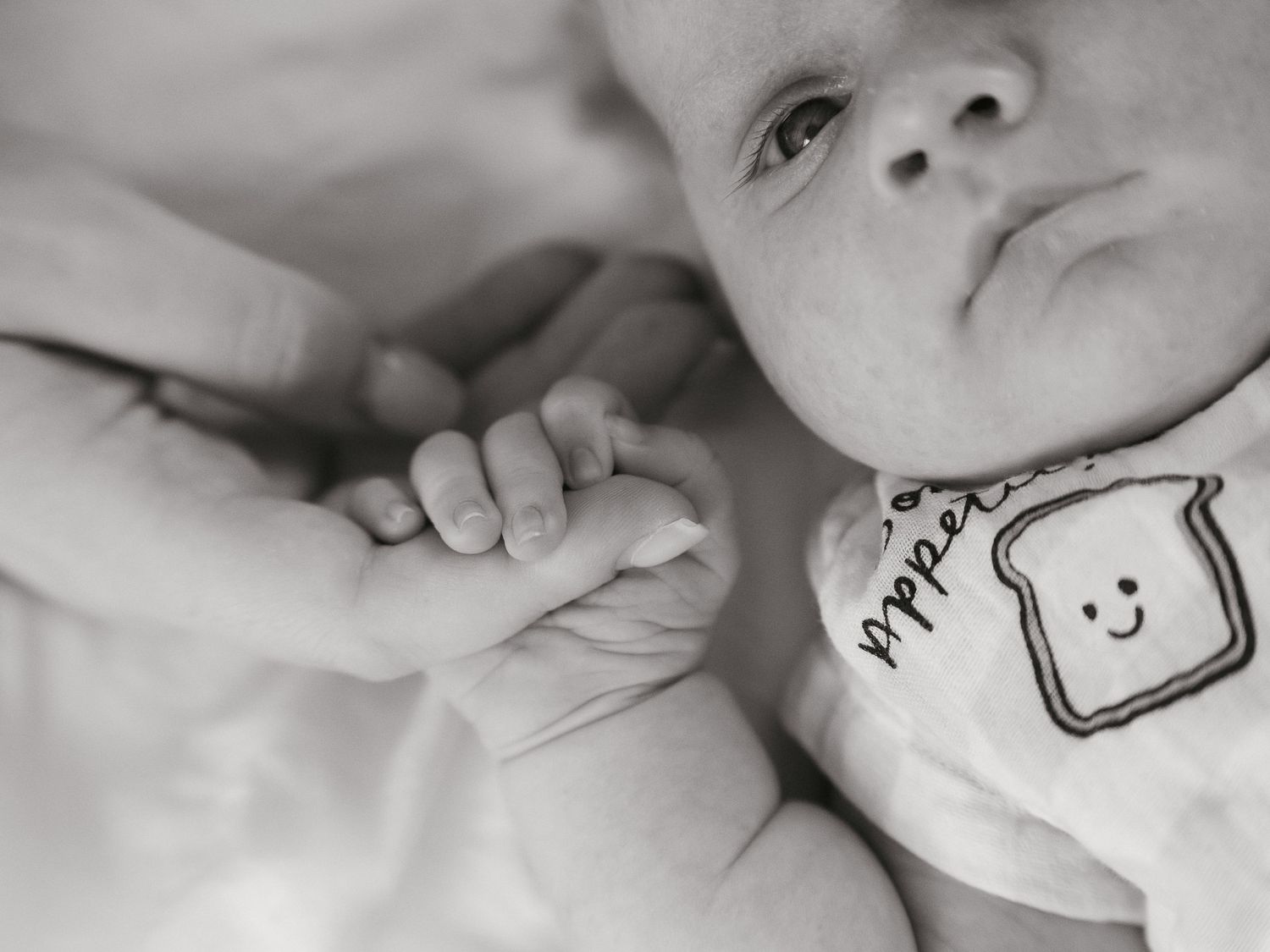 Baby holding on to mums finger