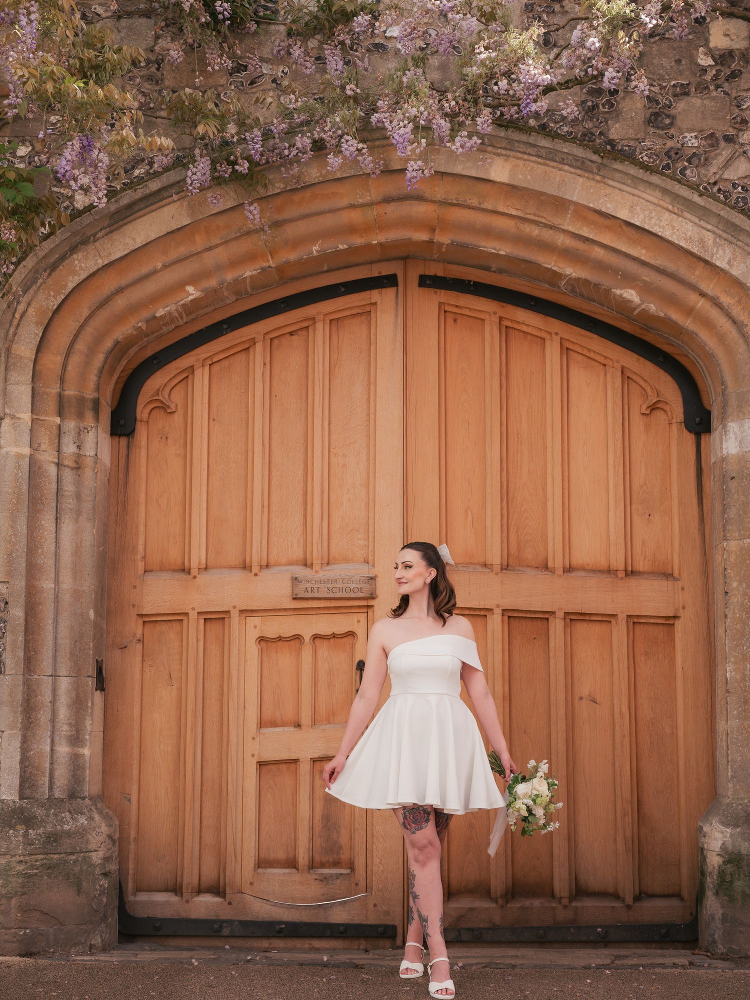 Bride waiting at large door, portrait editorial in Winchester