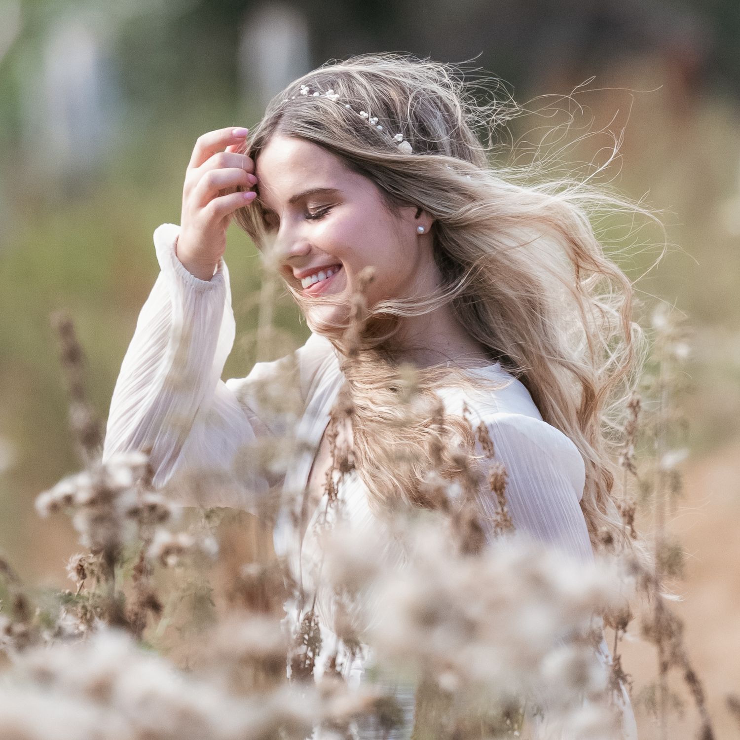 laughing woman amongst field and flowers