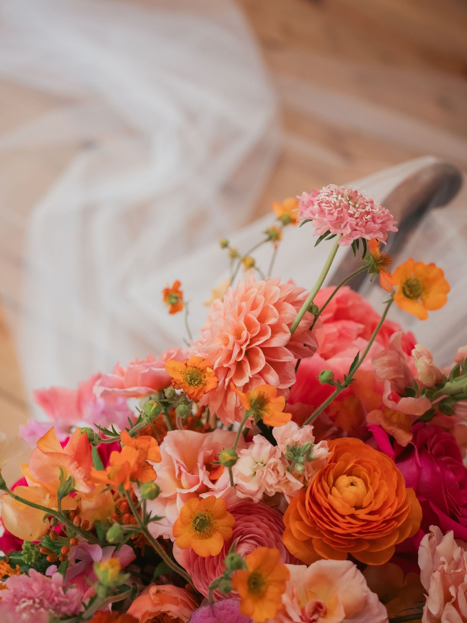 Close up shot of colourful bouquet and veil