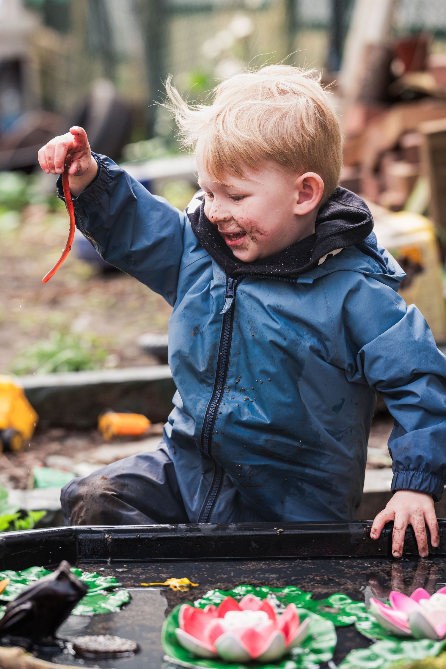 Toddler finds worm in mud