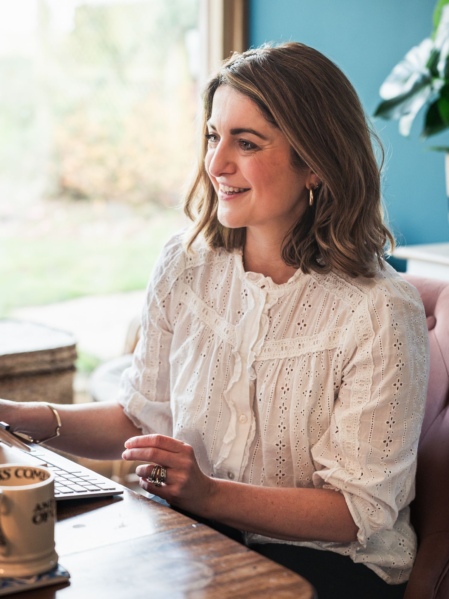Therapist looking off camera to her screen smiling during a video call