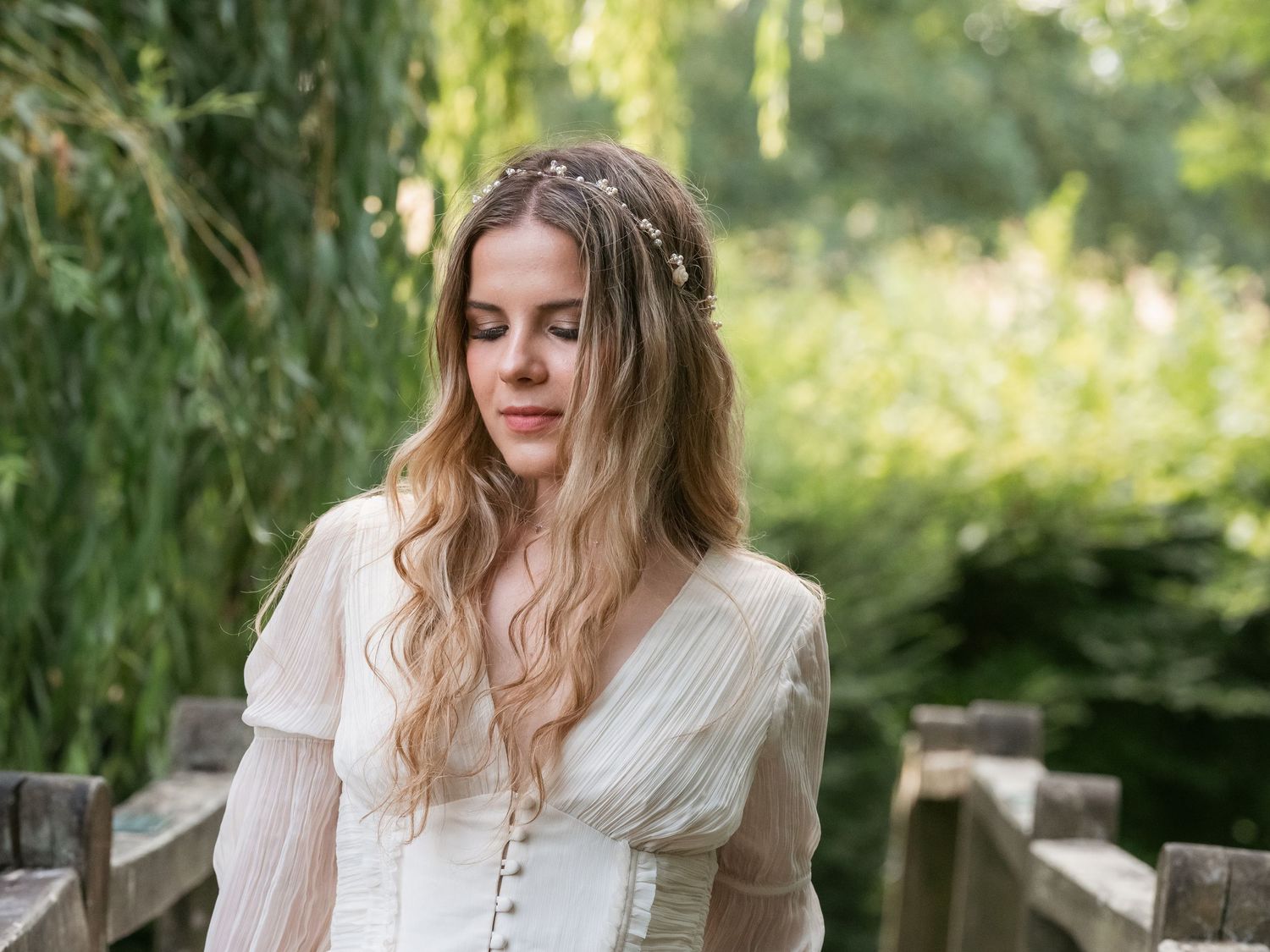 Bridal portrait outside crossing bridge by willow tree