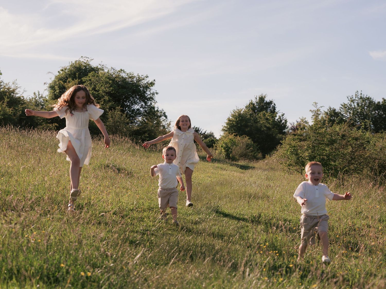 children running through field together