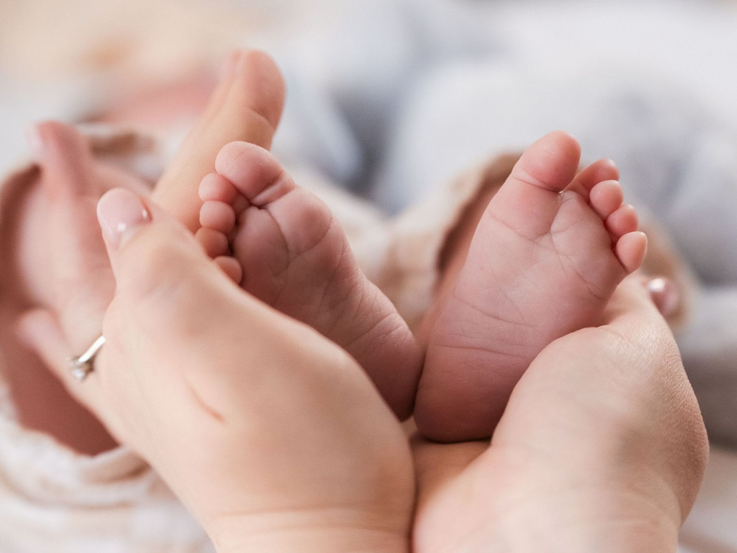 Newborn feet being held by mums hands