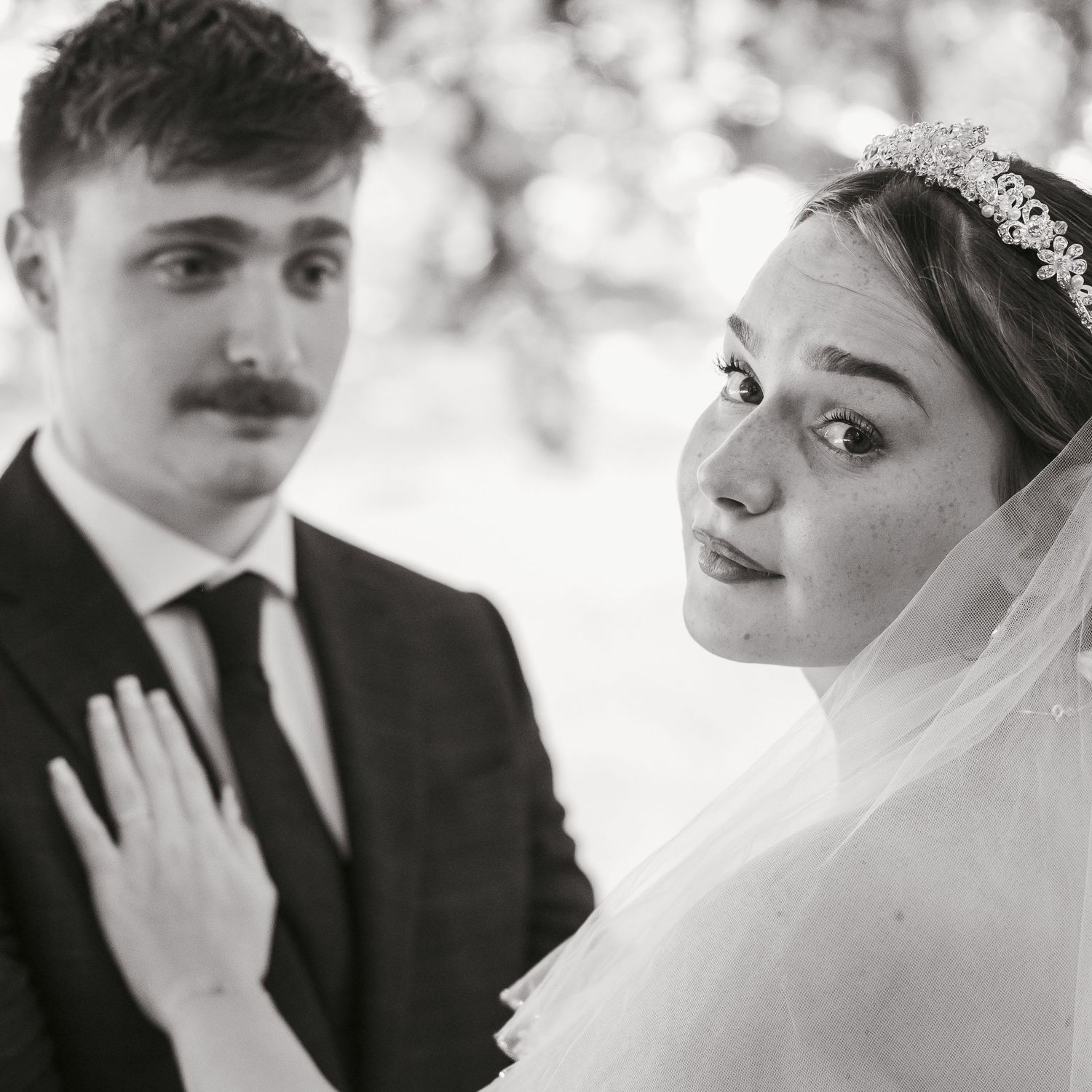 Bride and groom portrait, bride looking back over her shoulder