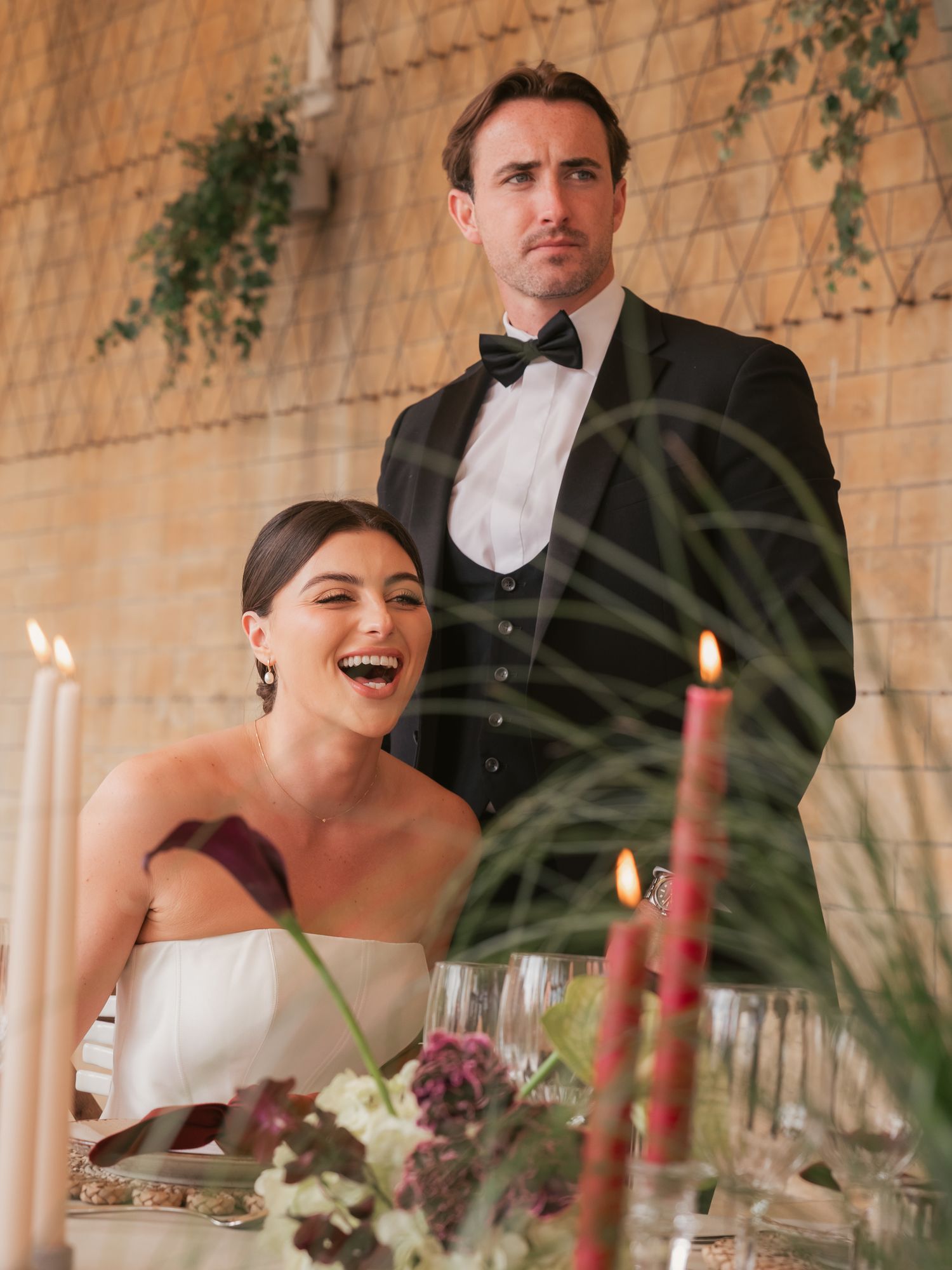 newly wed bride and groom laughing at reception