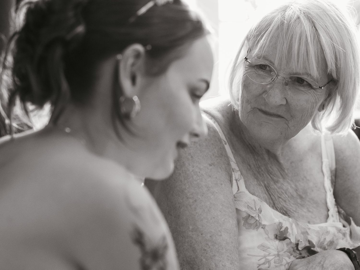 Candid of grandma looking lovingly at granddaughter/bride