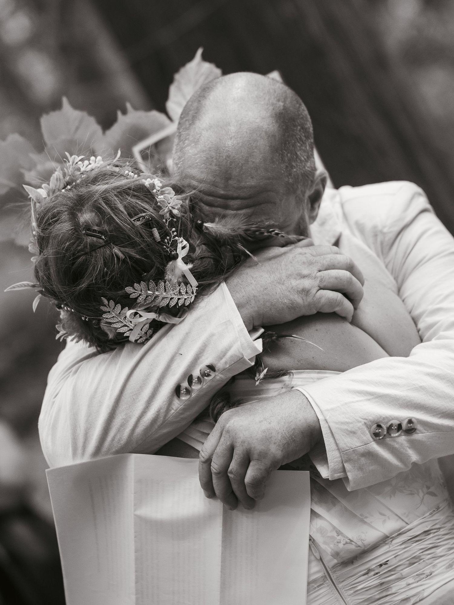 Couple embracing after reading their vows in the woods