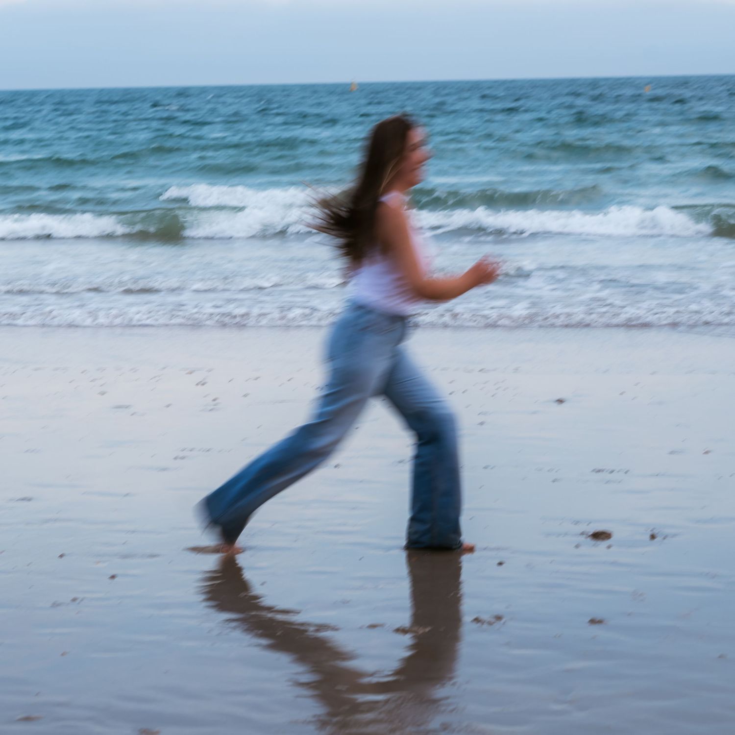 blur motion of woman running at the beach