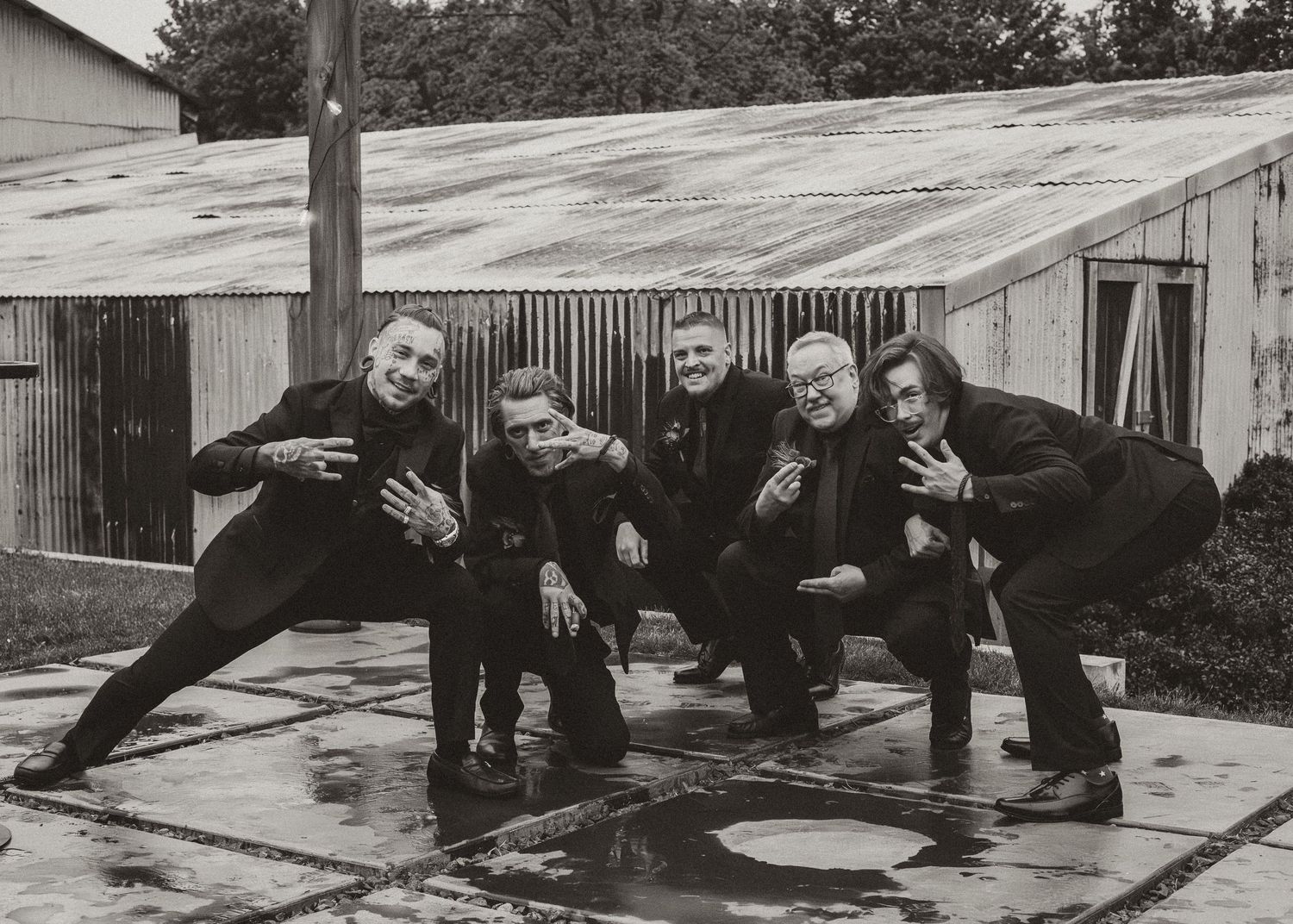 Black and white group portrait of friends posing together outdoors