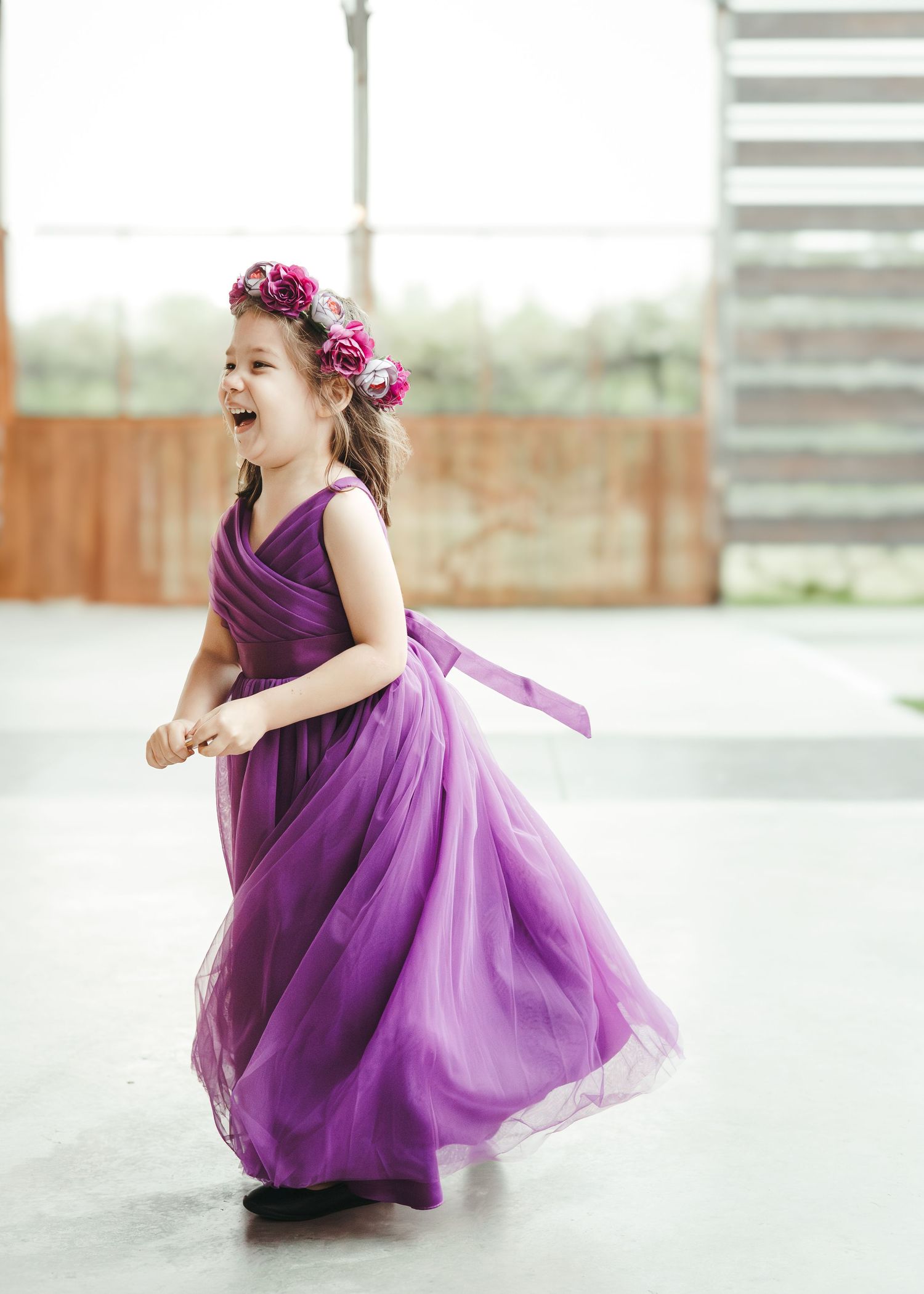 Young girl in a purple dress photographed outdoors
