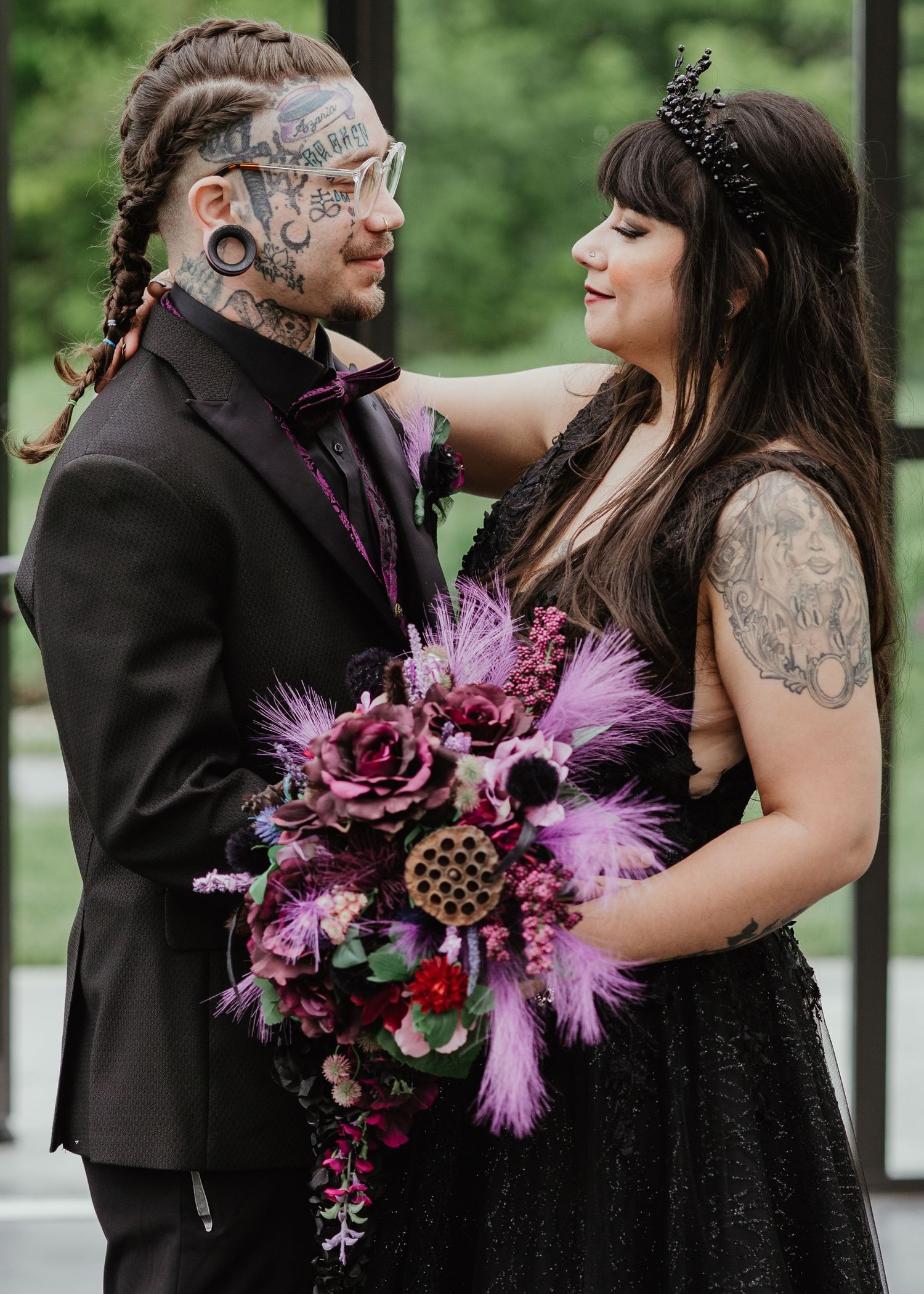 Wedding couple embracing outdoors, with the bride holding a colorful bouquet