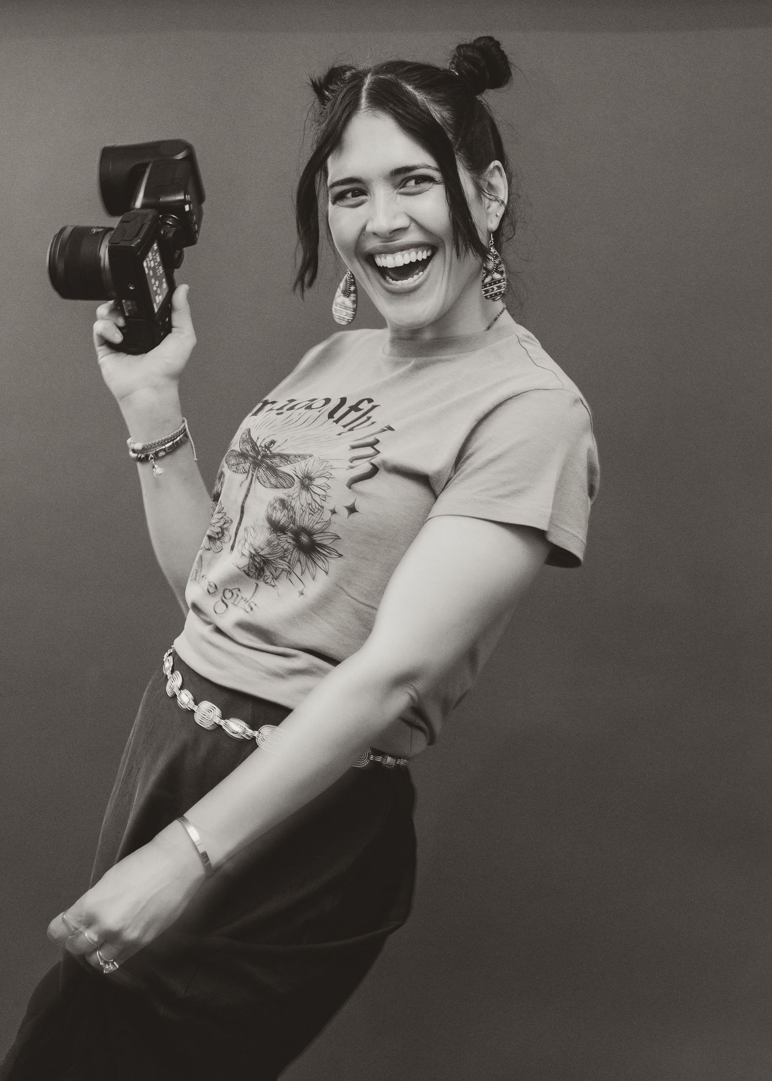 Black and white portrait of a woman holding a camera