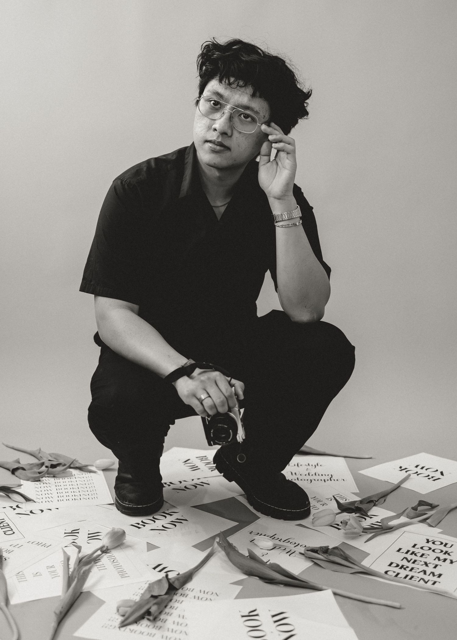 Black and white studio portrait of a man dressed in black