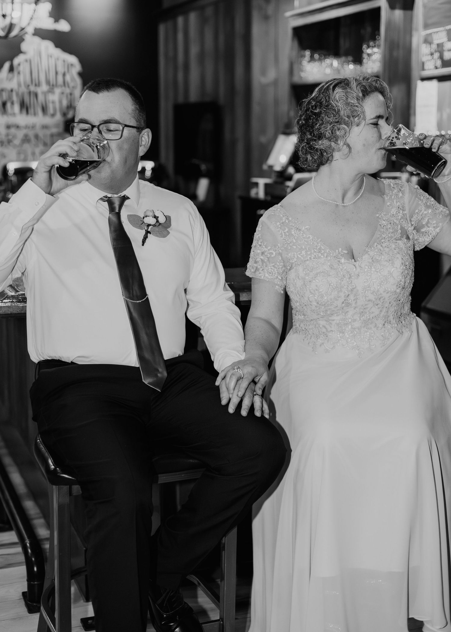 Black and white wedding portrait of a bride and groom seated together