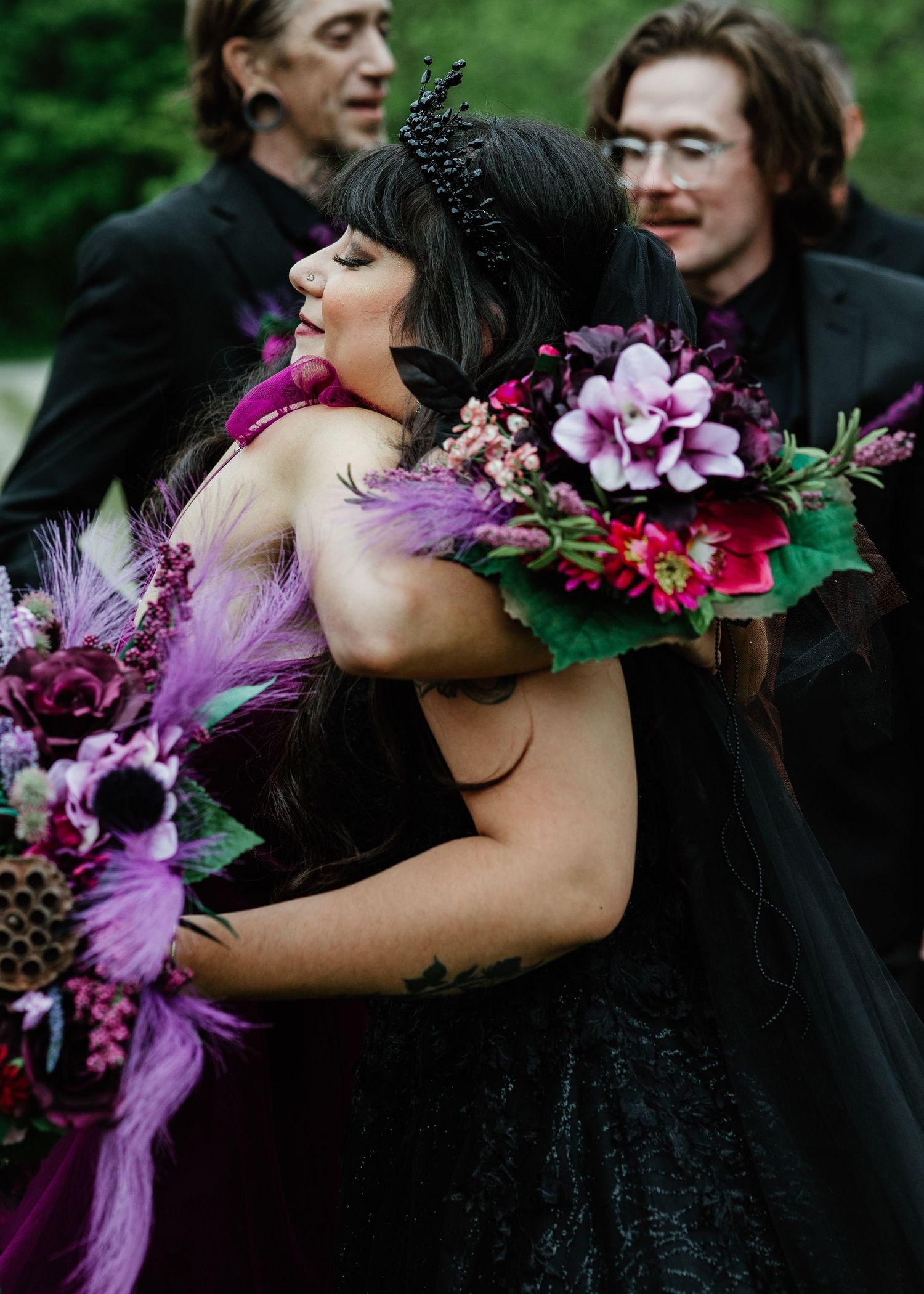 Wedding couple embracing with a colorful bouquet of flowers outdoors