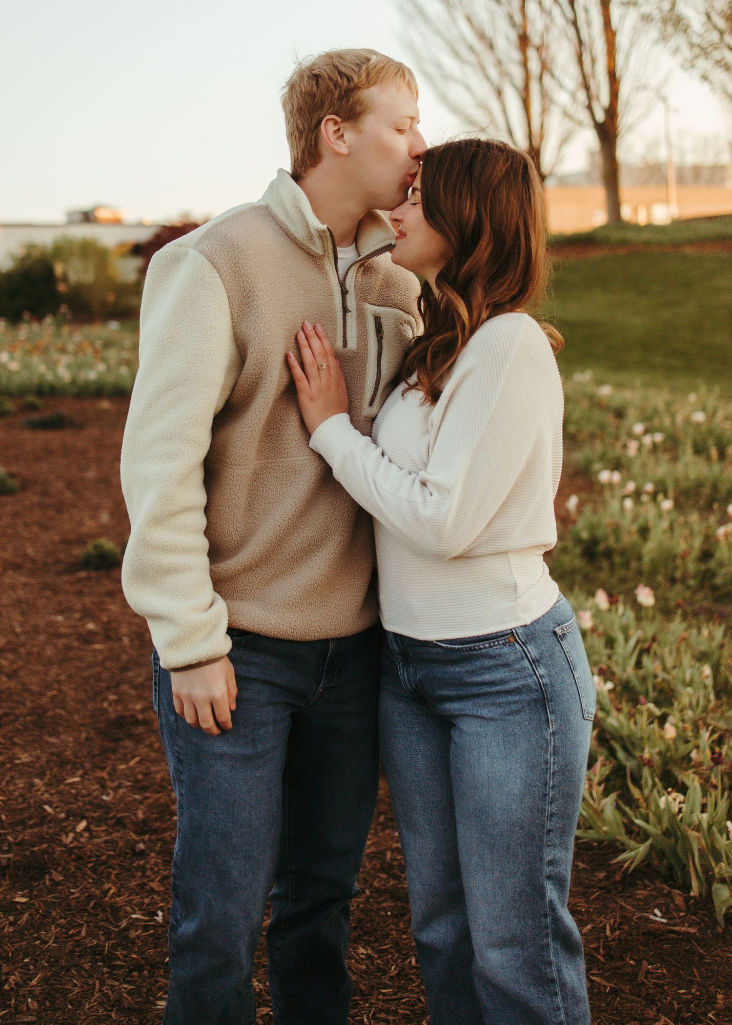 Couple embracing during an outdoor engagement portrait session