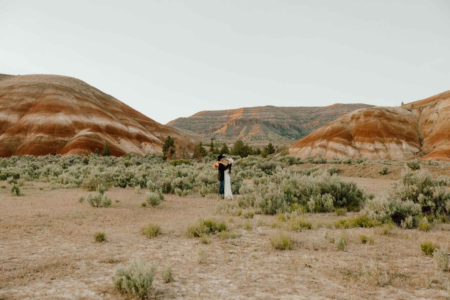 Couple portrait in colorful Eastern Oregon desert landscape by Baker City photographer
