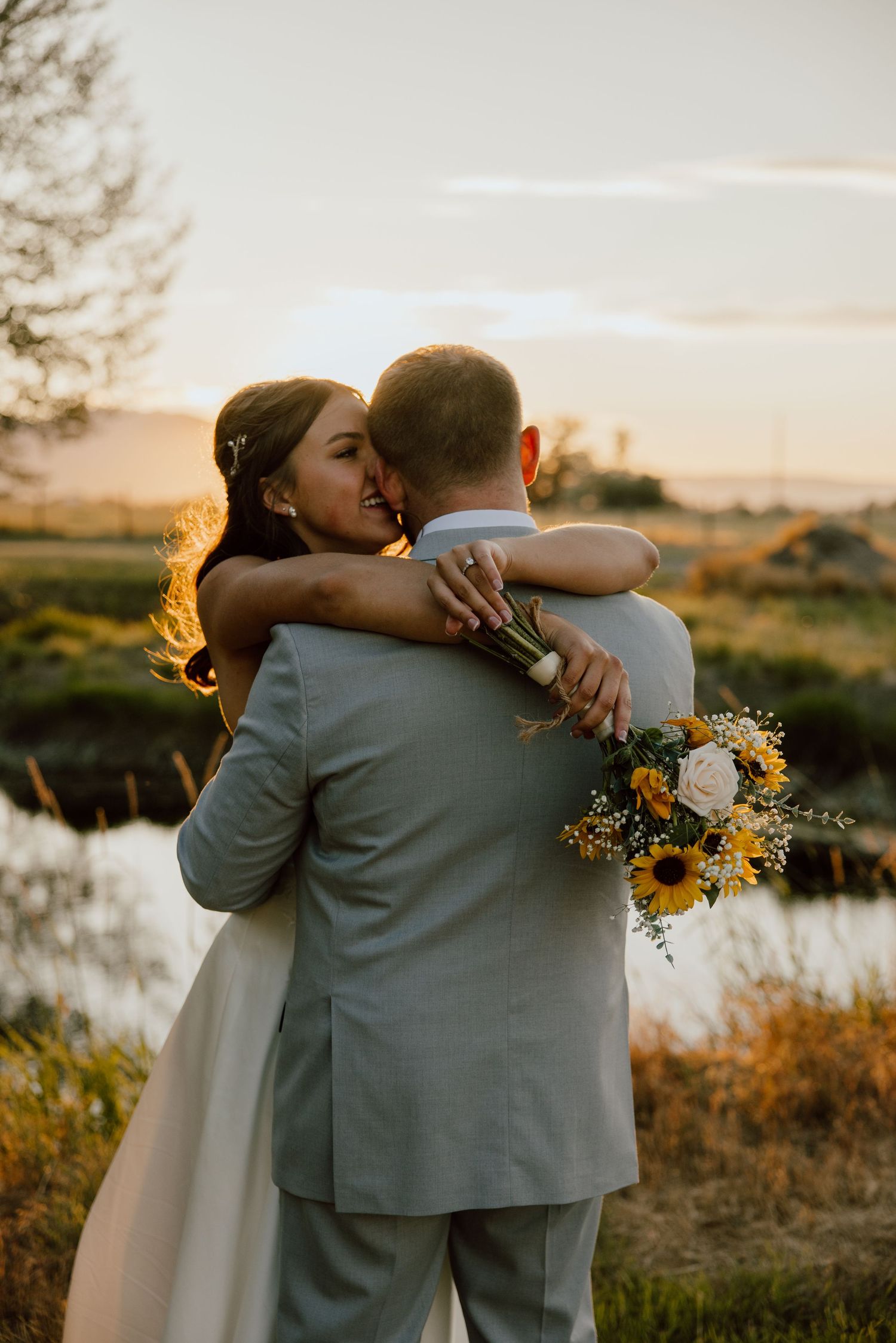 Bride and groom embracing outdoors with bouquet, Eastern Oregon wedding photography