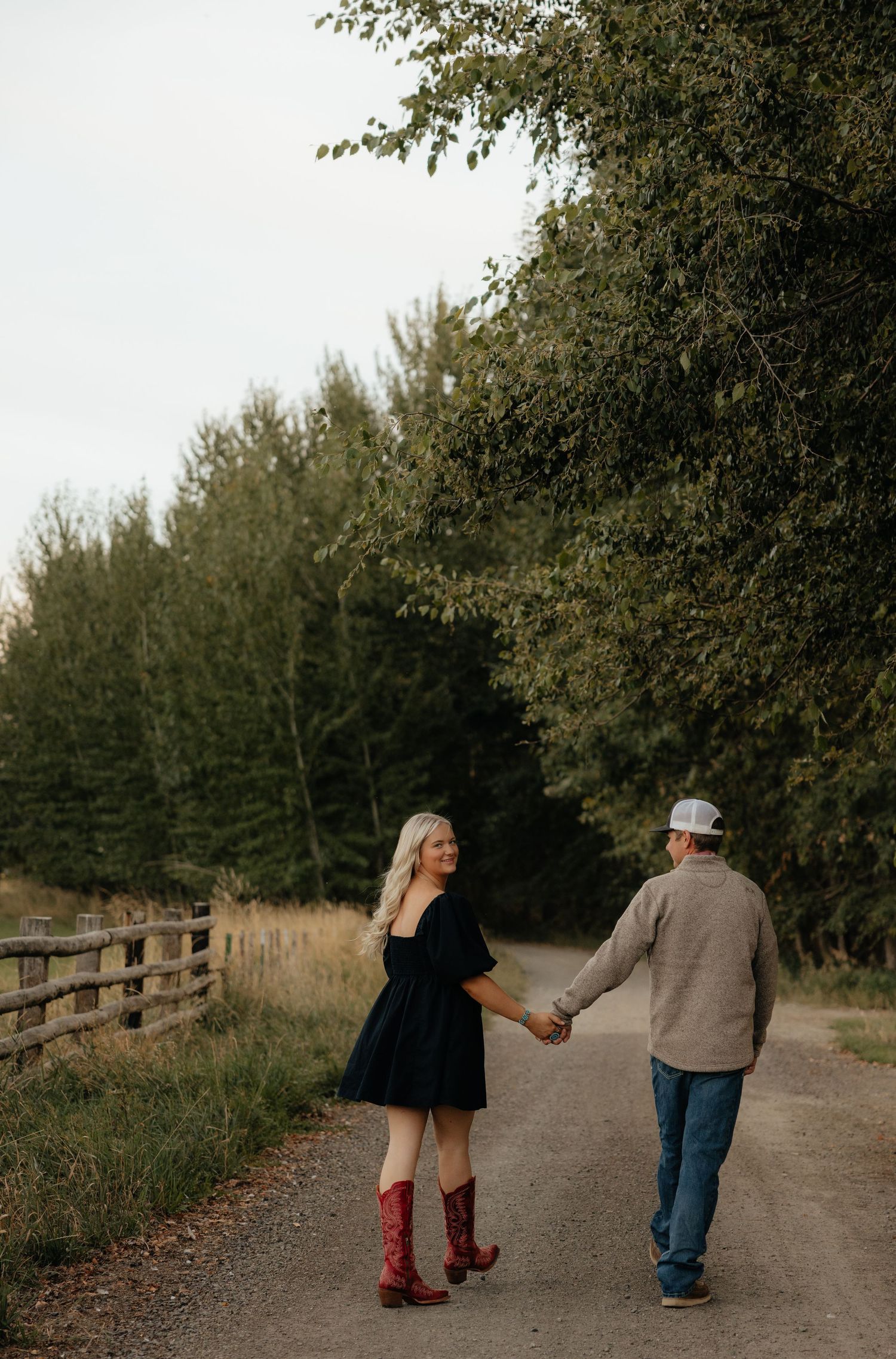 Couple walking hand in hand on rustic path, Eastern Oregon engagement photography