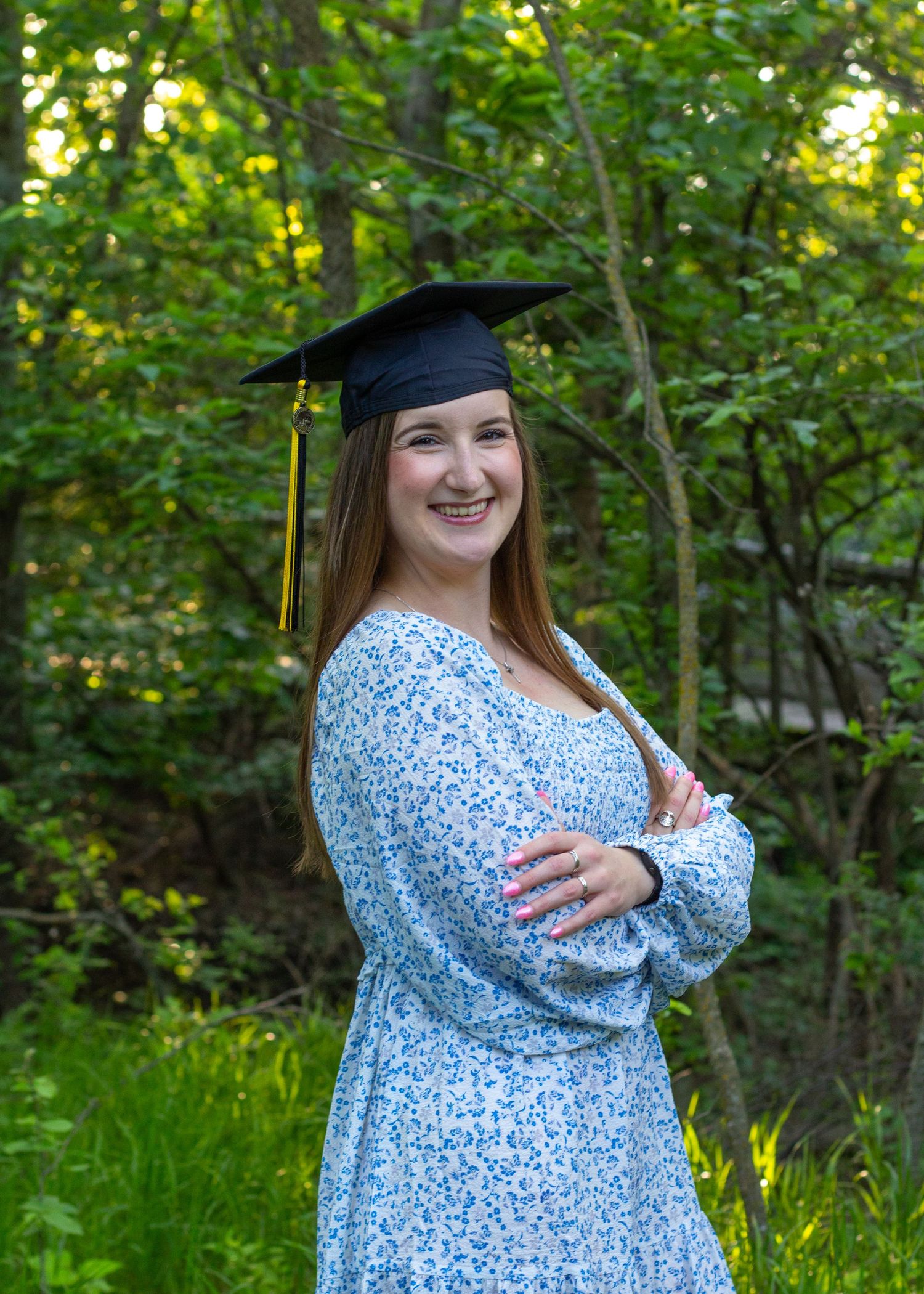 A girl in a graduation cap outside.