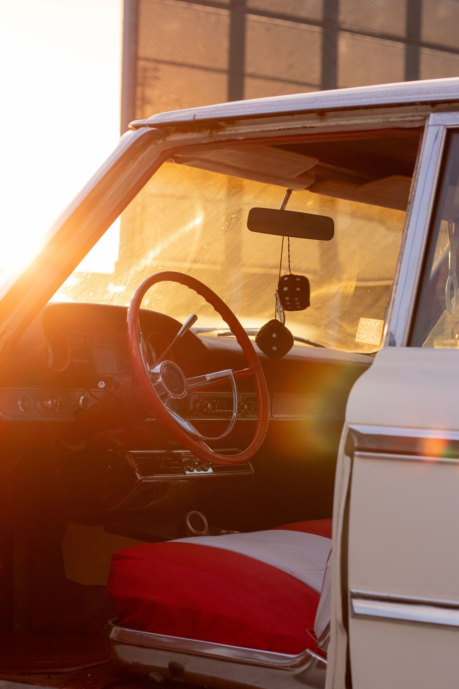 The steering wheel of a Ford Galaxie at sunset.