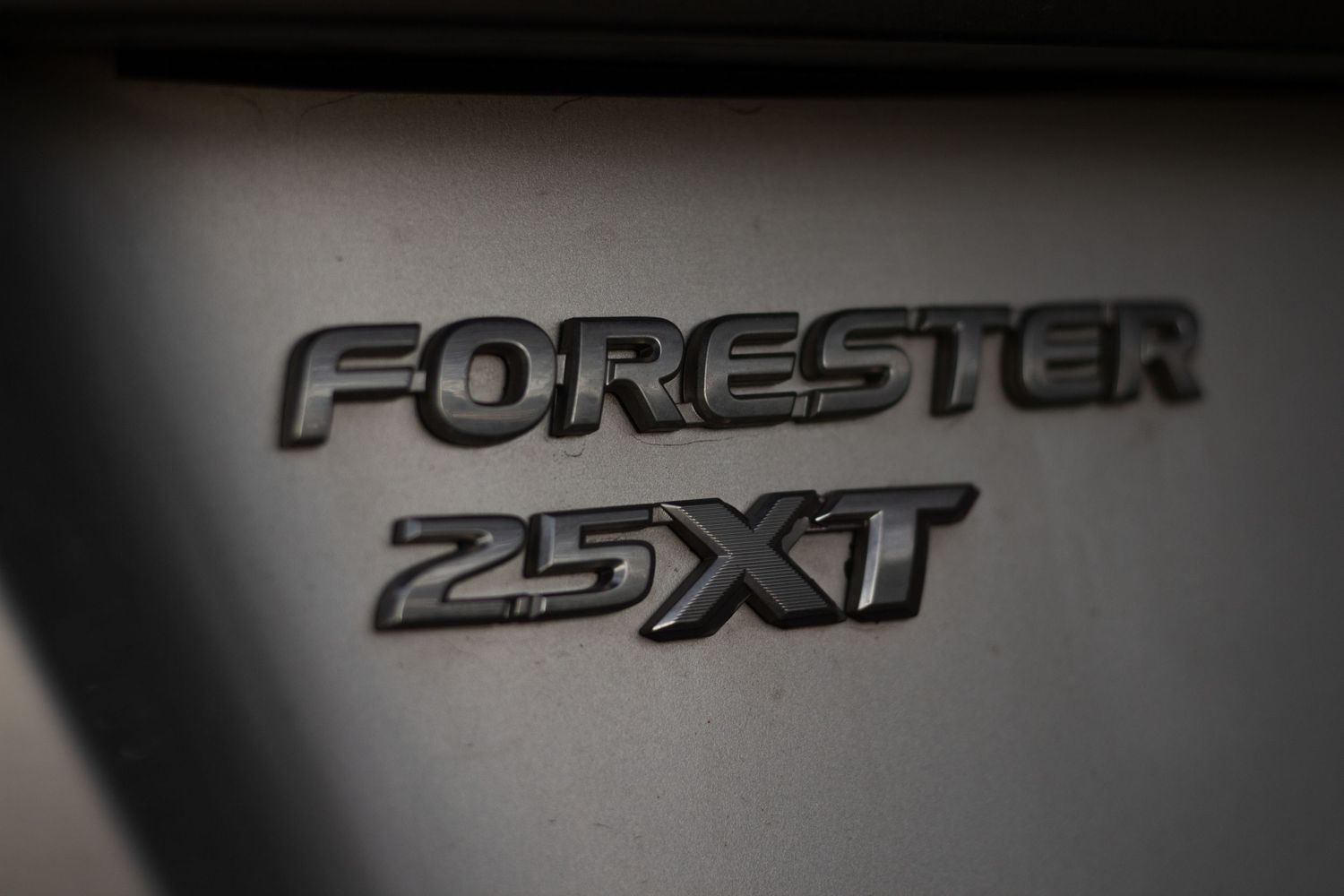 The badges on a Subaru Forester XT.