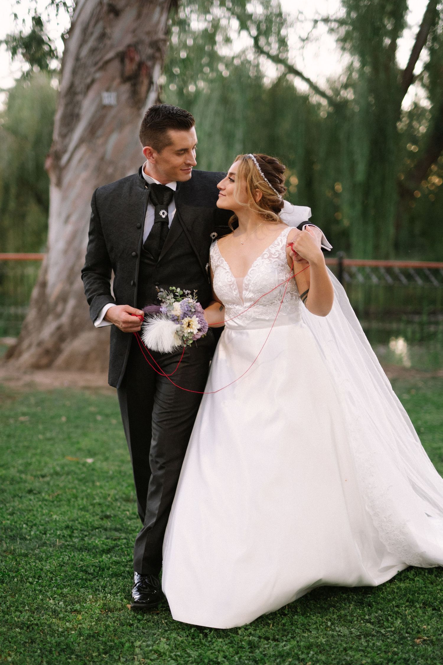 A joyful wedding moment photographed against tall eucalyptus trees in an outdoor setting.
