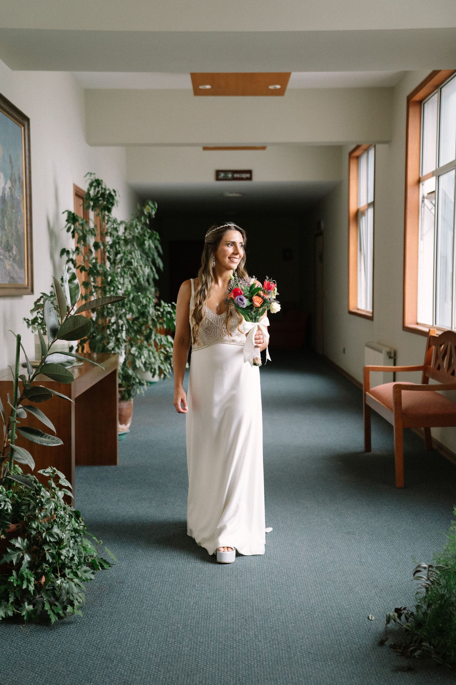 A sequence of wedding photos showing a bride walking down a hallway with green carpeting and indoor plants.