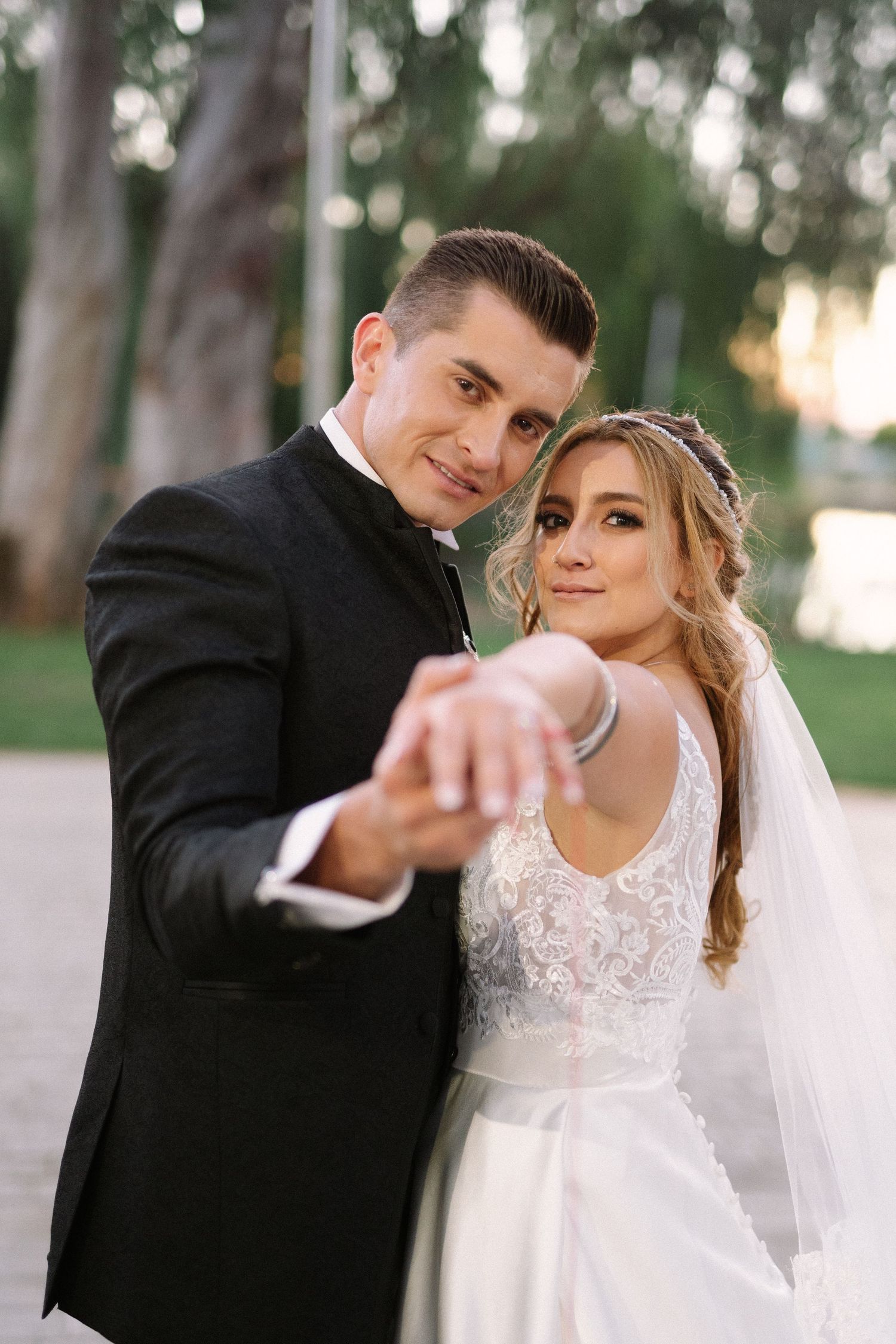 A wedding couple shares an intimate dance pose outdoors during their wedding photoshoot.