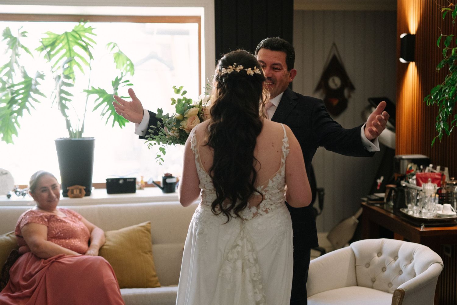 First look reaction between bride and groom in elegant indoor setting.