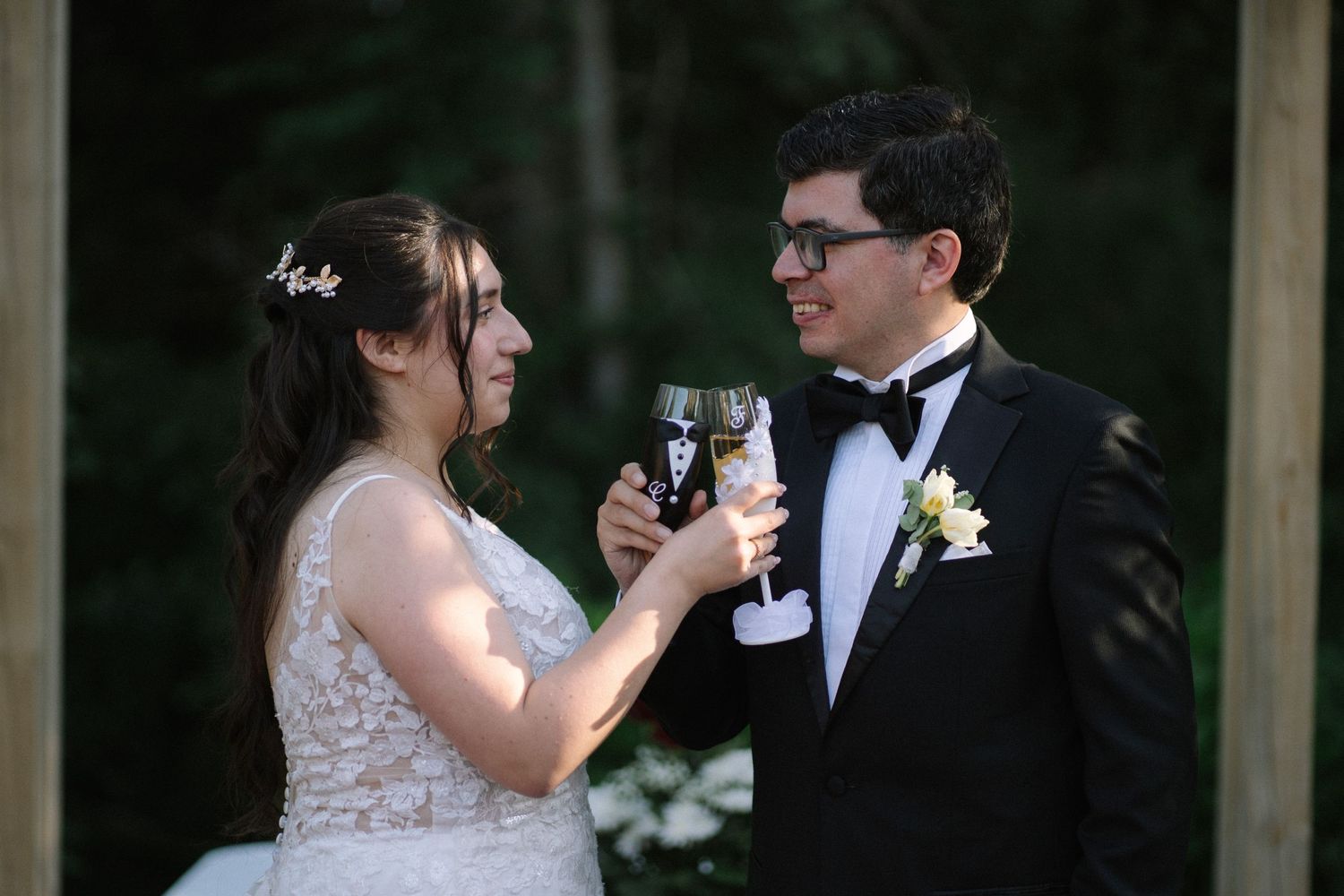 Formal wedding celebration toast with champagne glasses.