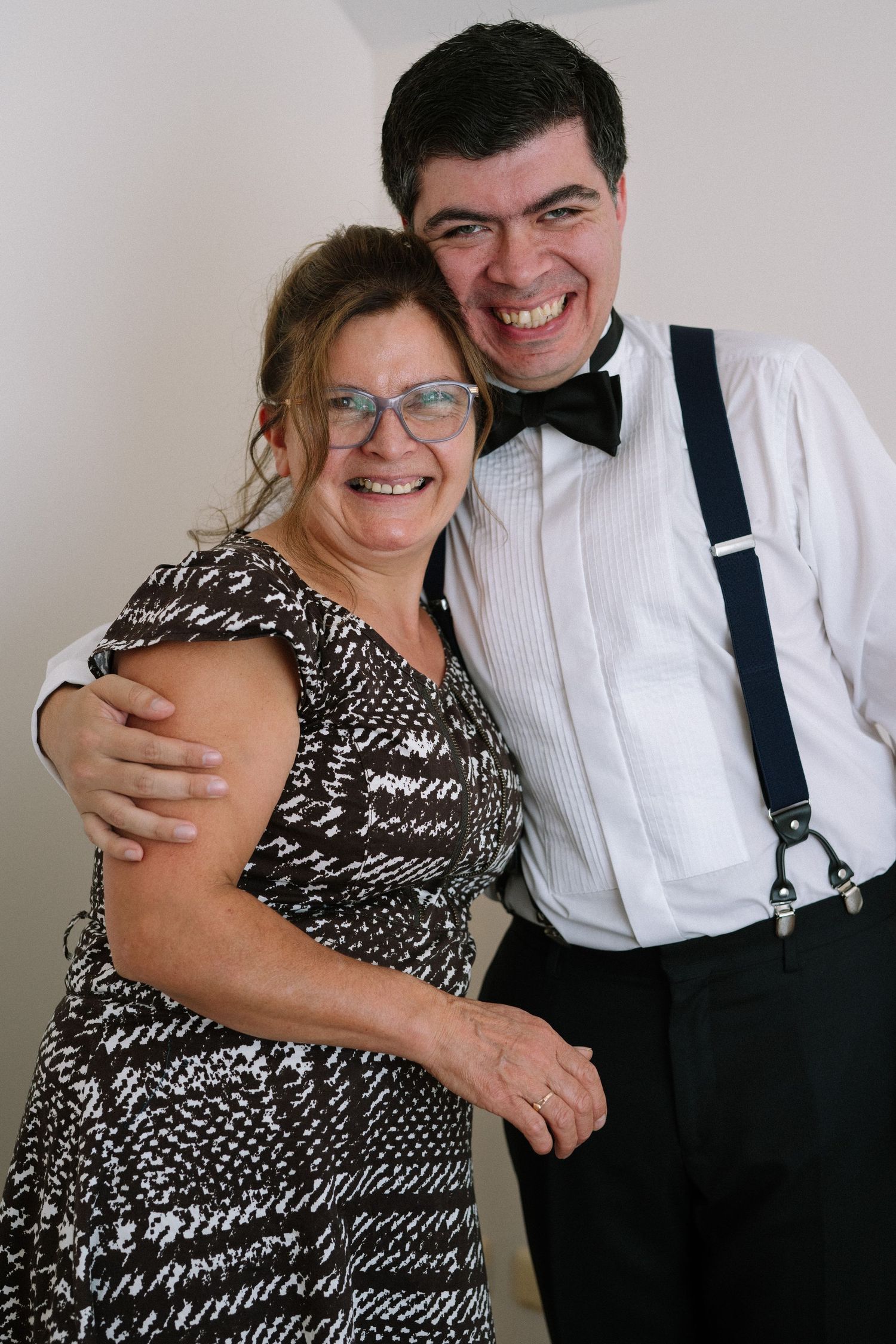Joyful couple in formal attire share a tender moment together.