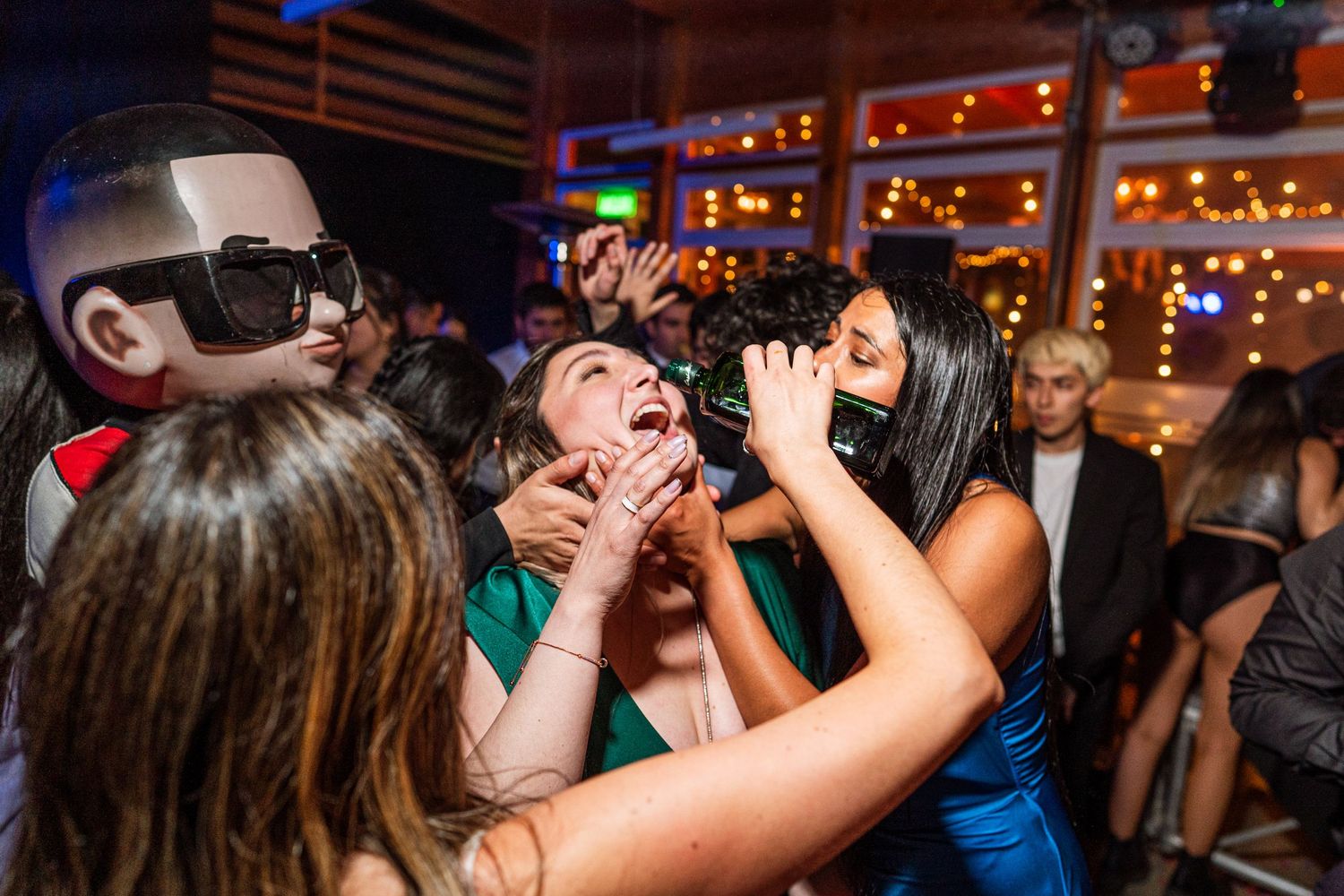 Energetic party scene with guests having fun under club lighting.