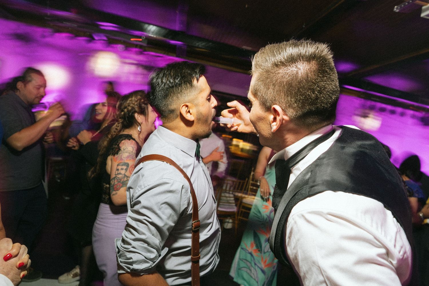 Wedding guests sing karaoke enthusiastically during the reception party.