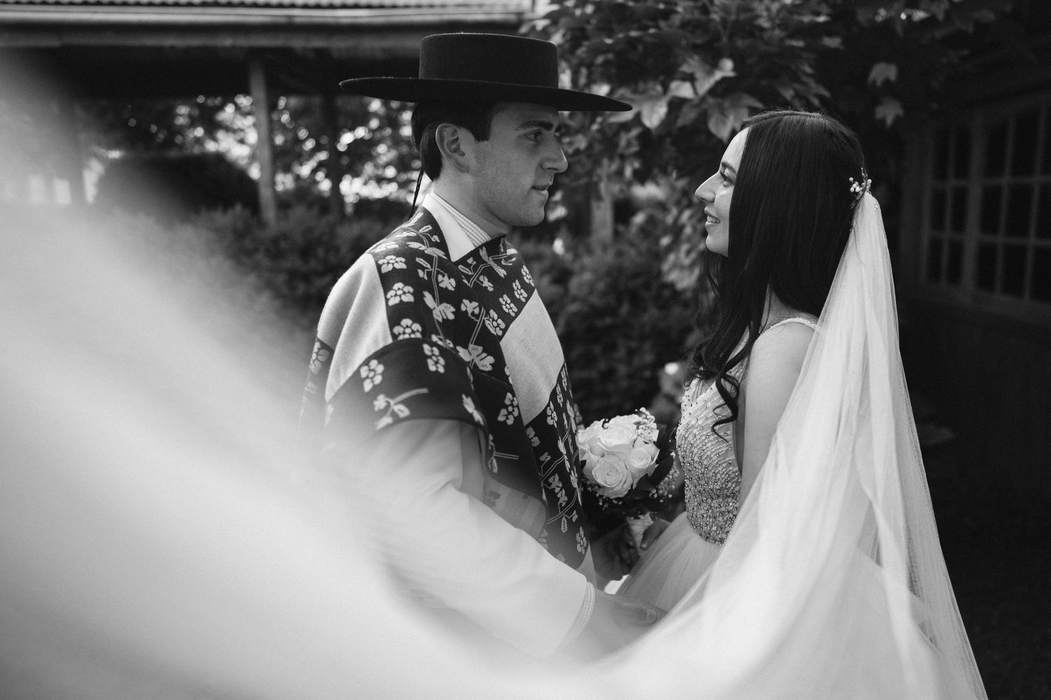 Intimate wedding moment captured in black and white with soft focus effect.