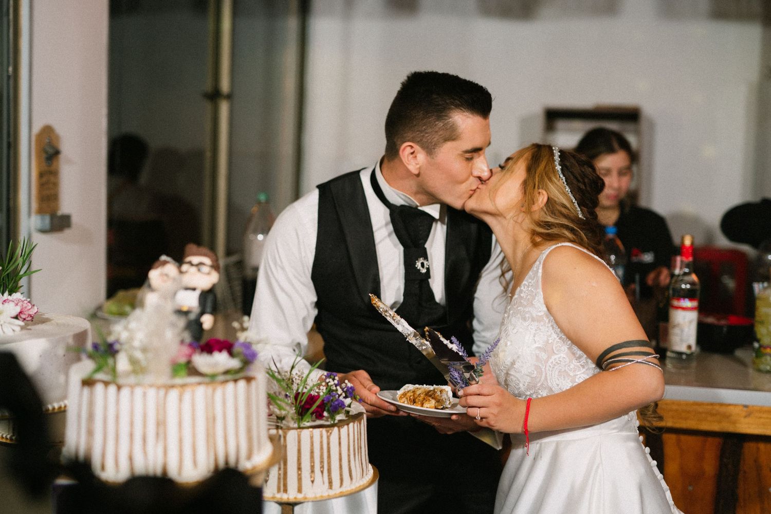 A sweet moment between newlyweds sharing their first bite of wedding cake together.