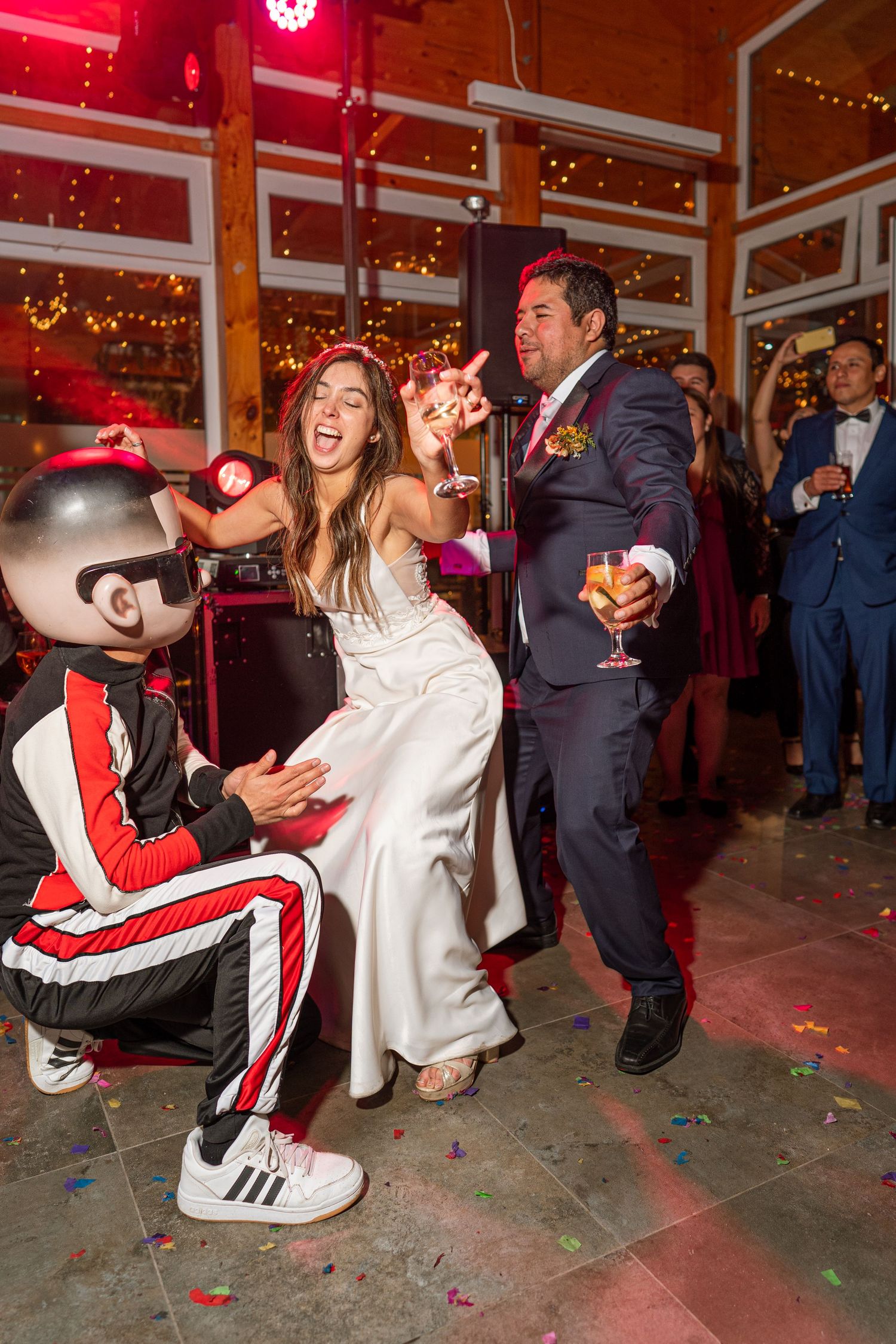 Wedding celebration with dancers and performer in athletic wear on the dance floor.